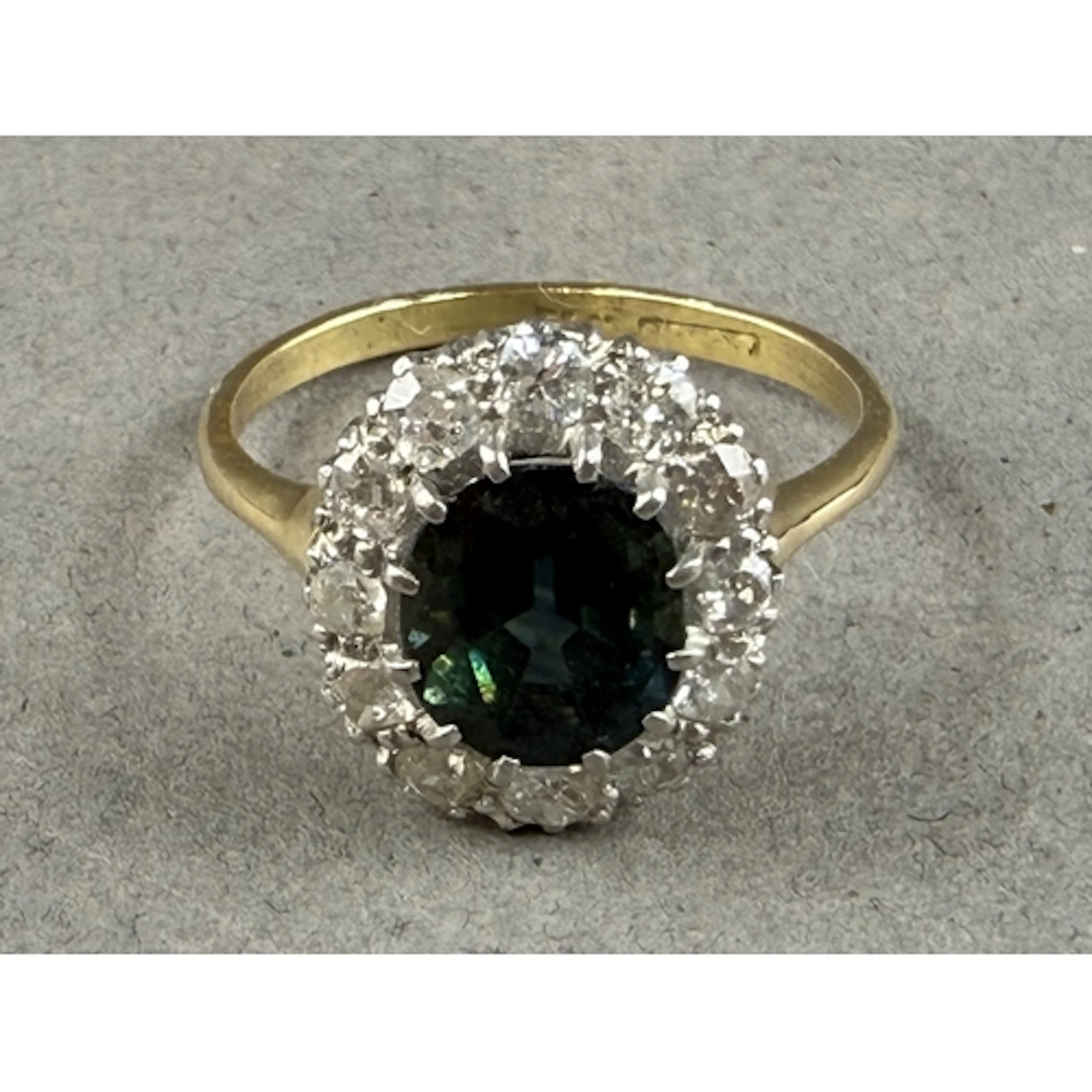 Jewellery: a yellow metal, sapphire and diamond cluster ring...