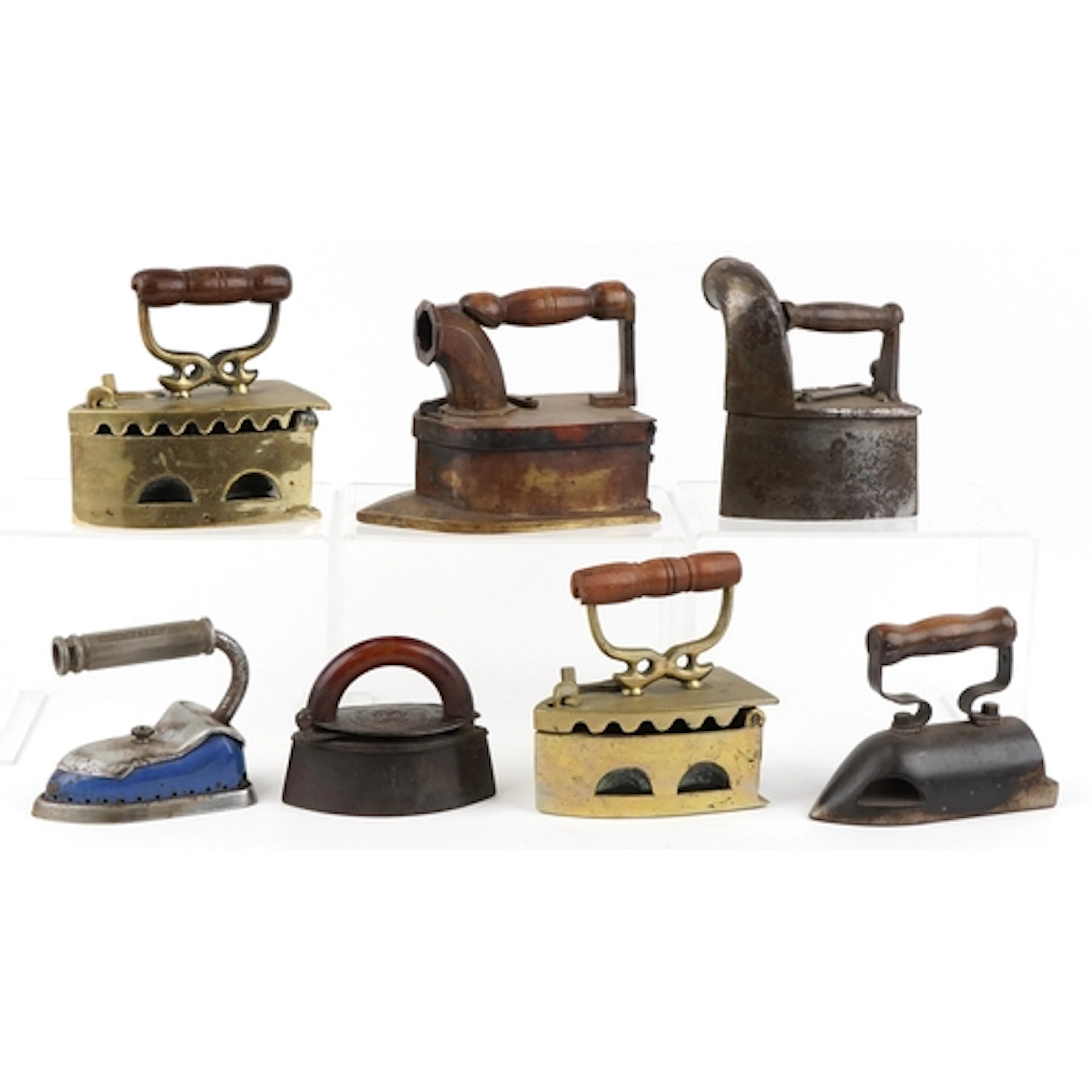 Seven antique coal fired and flat irons including brass exam...