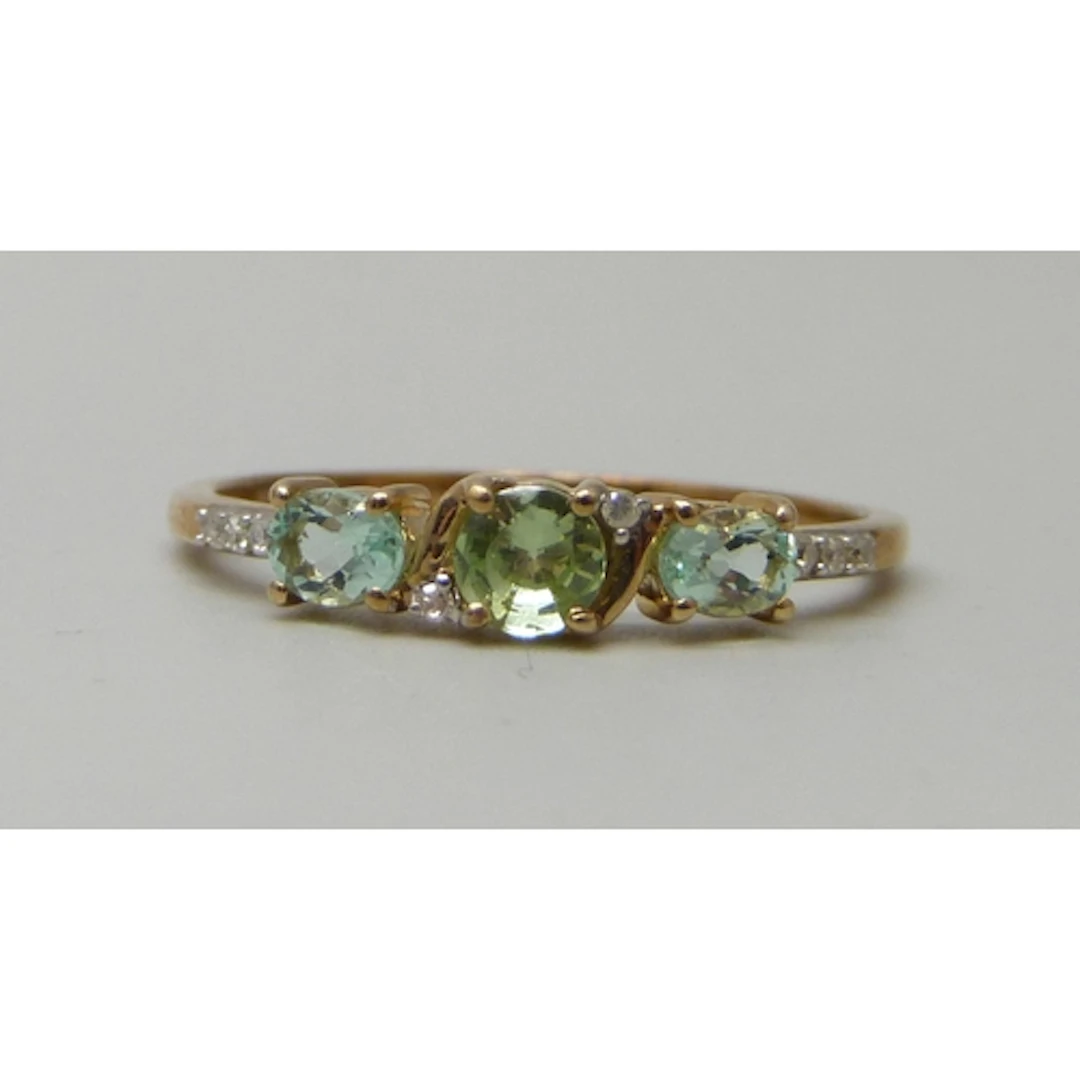 A 9ct gold, peridot, possibly aquamarine, and diamond ring, ...