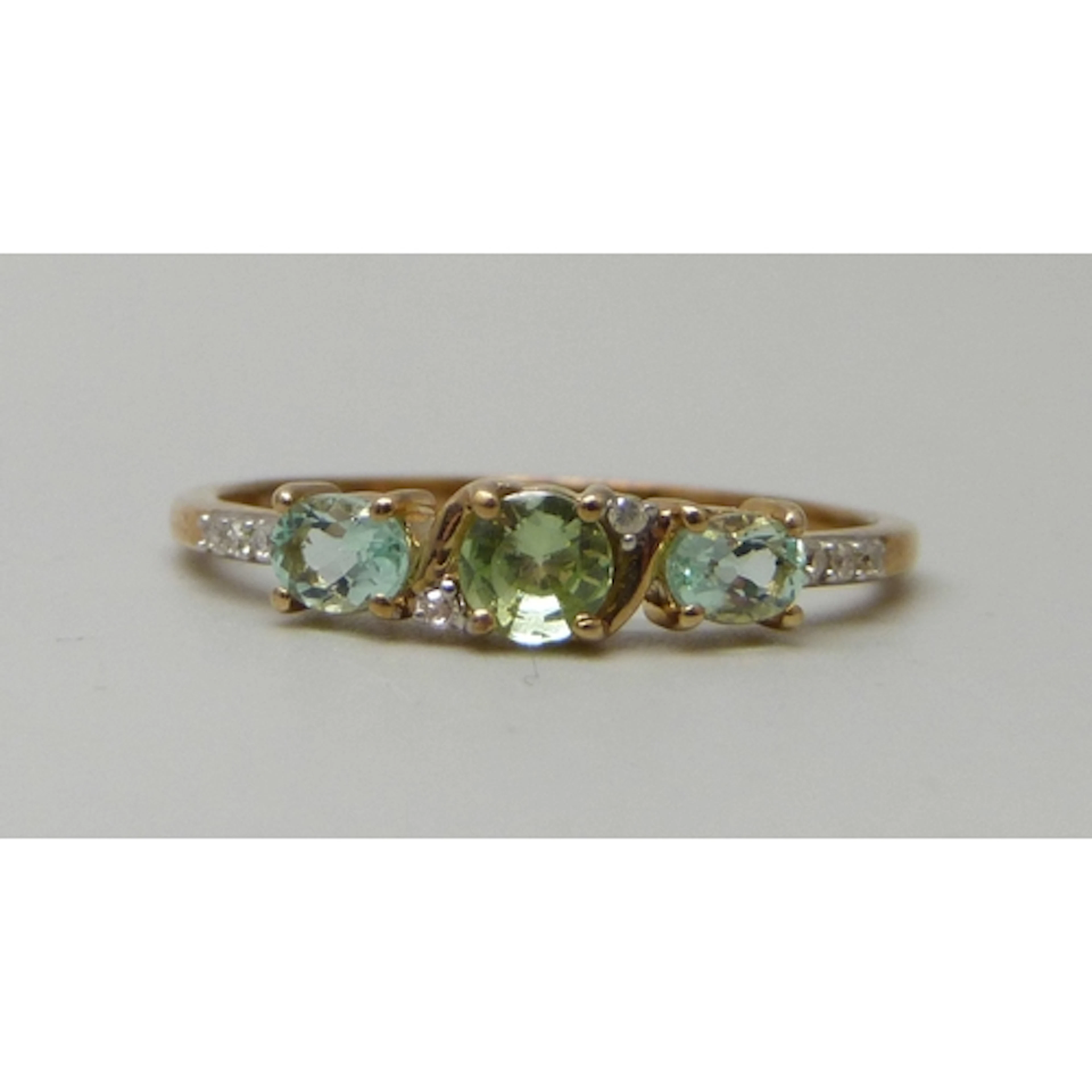 A 9ct gold, peridot, possibly aquamarine, and diamond ring, ...