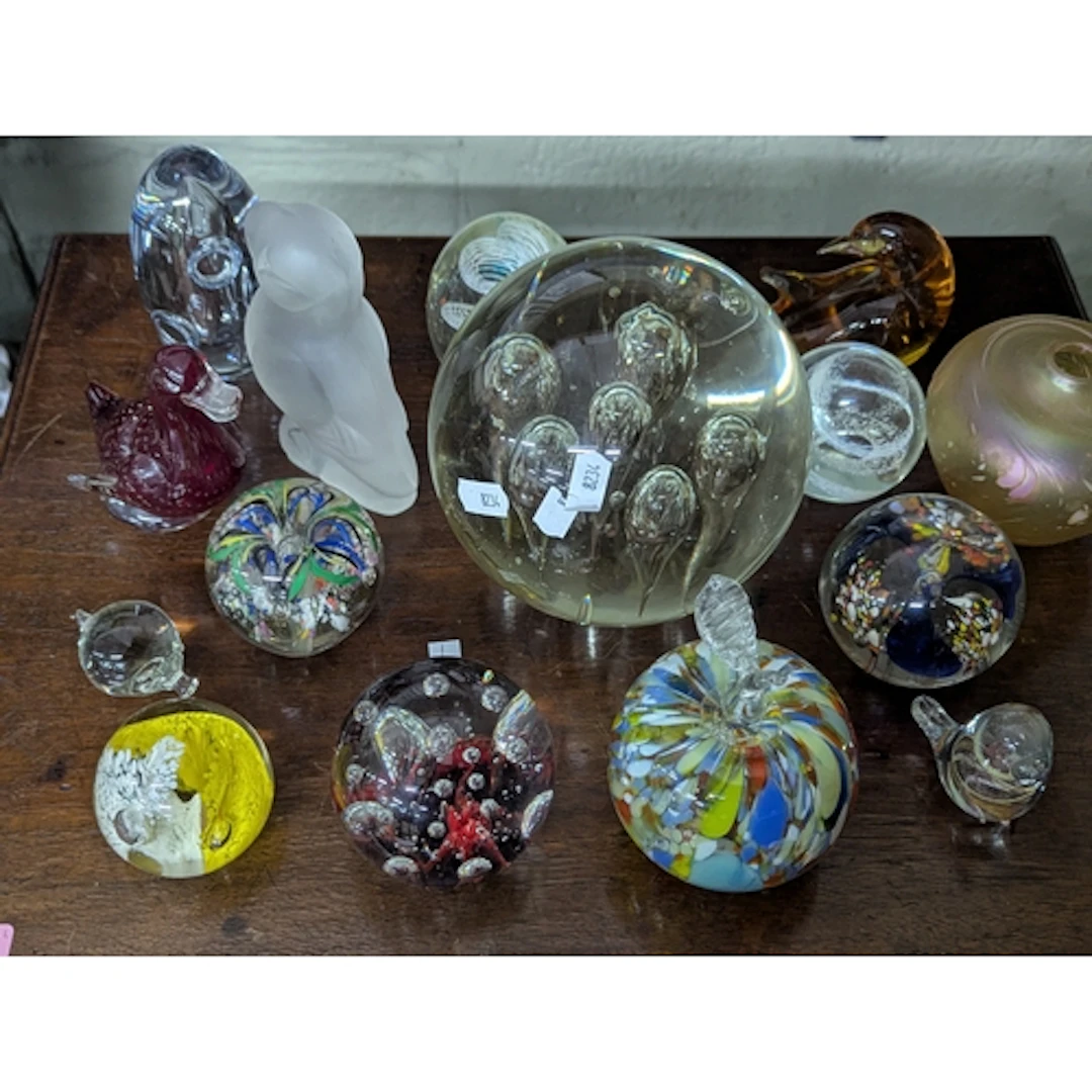 A collection of paperweights and art glass to include a Stro...