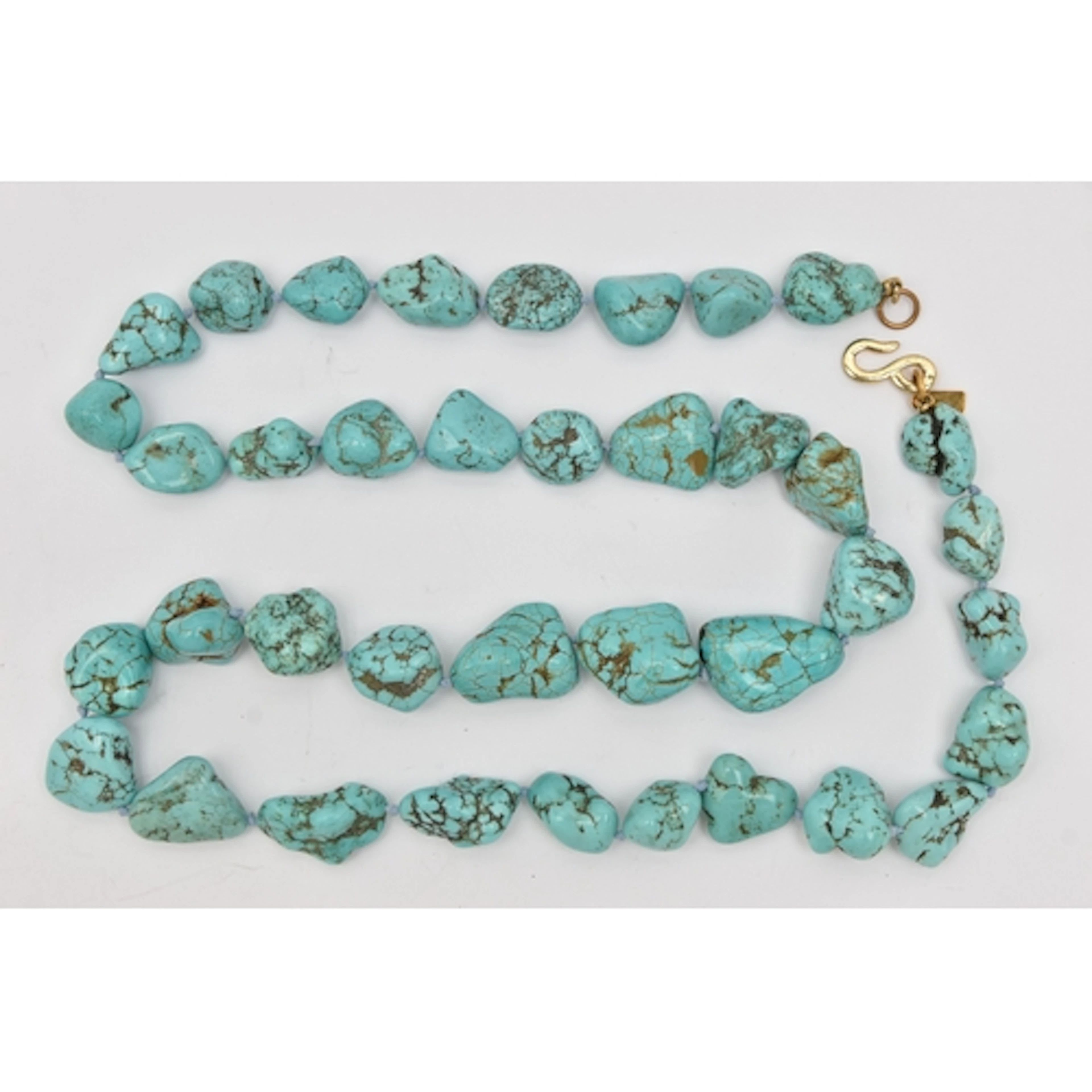 A 'KENNETH LANE' TURQUOISE BEAD NECKLACE, individually knott...
