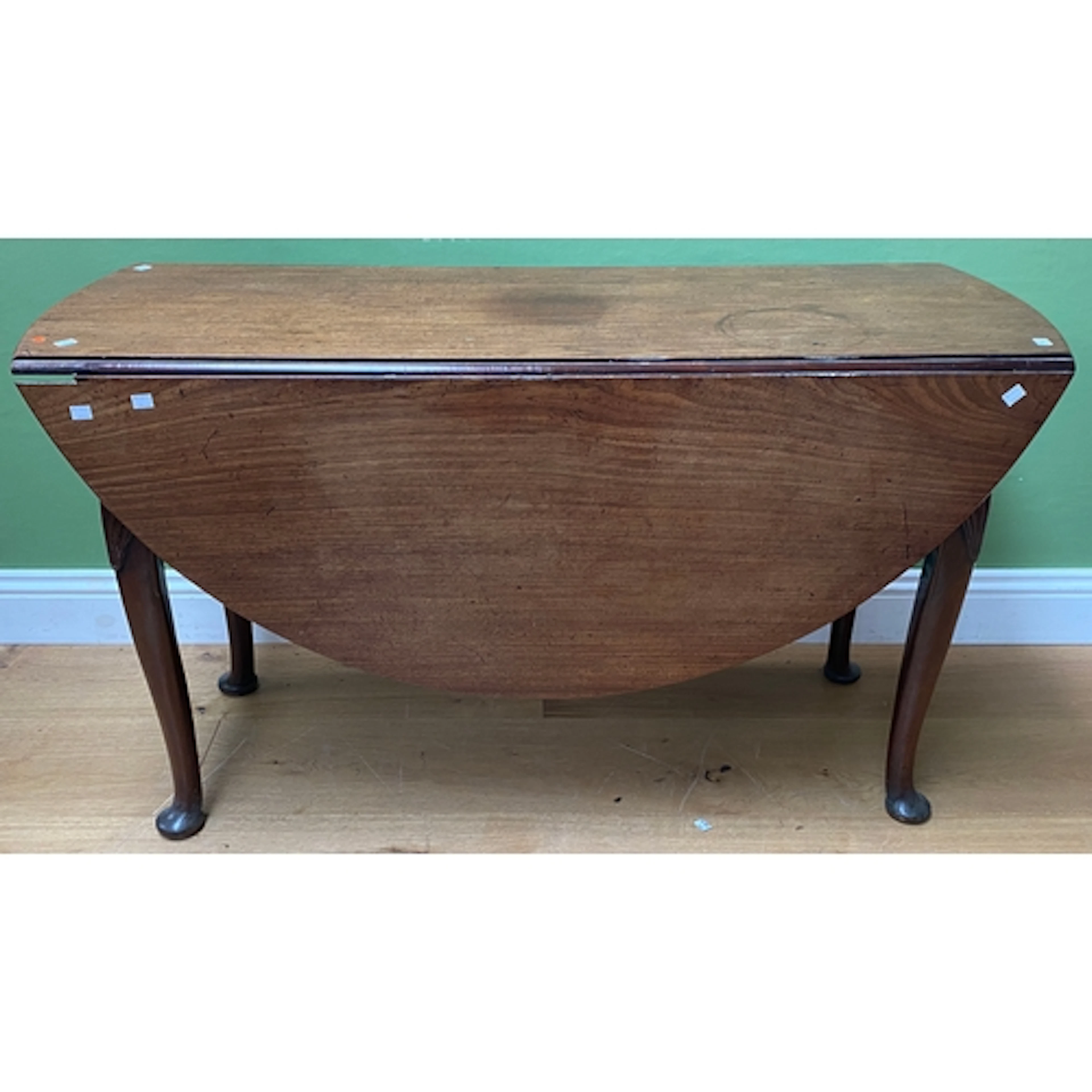 An 18th century mahogany oval gateleg table on shell carved ...