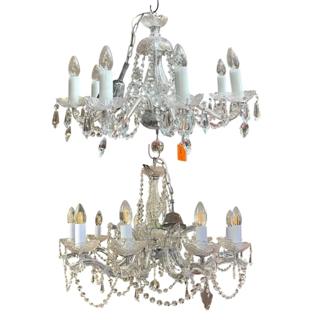 A near pair of 8-arm classical glass chandeliers. The ornate...