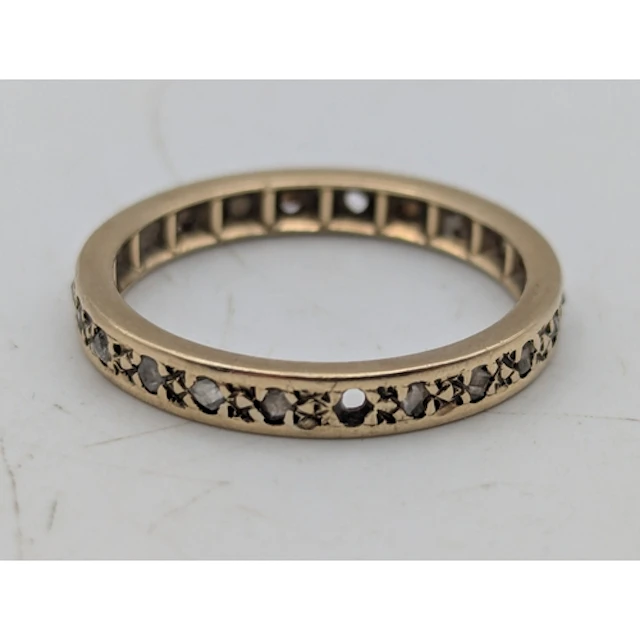 A diamond and yellow metal full eternity ring, two stones mi...