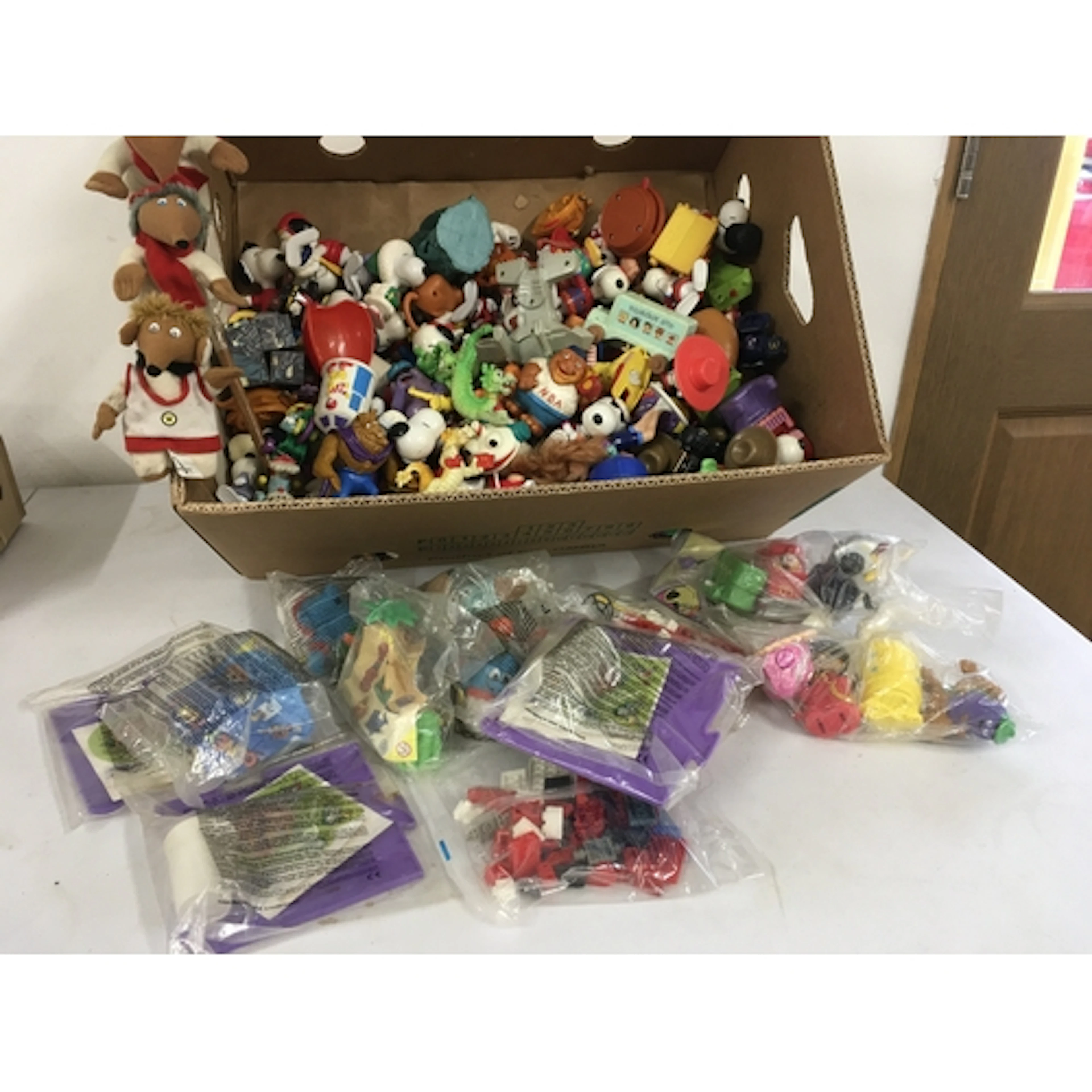 A box containing a large number of figures depicting many ch...