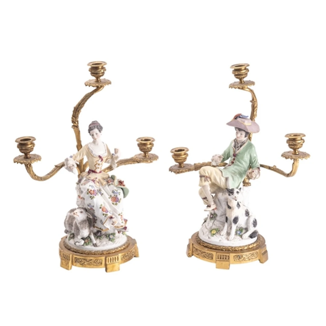 A pair of Continental gilt bronze and porcelain mounted figu...