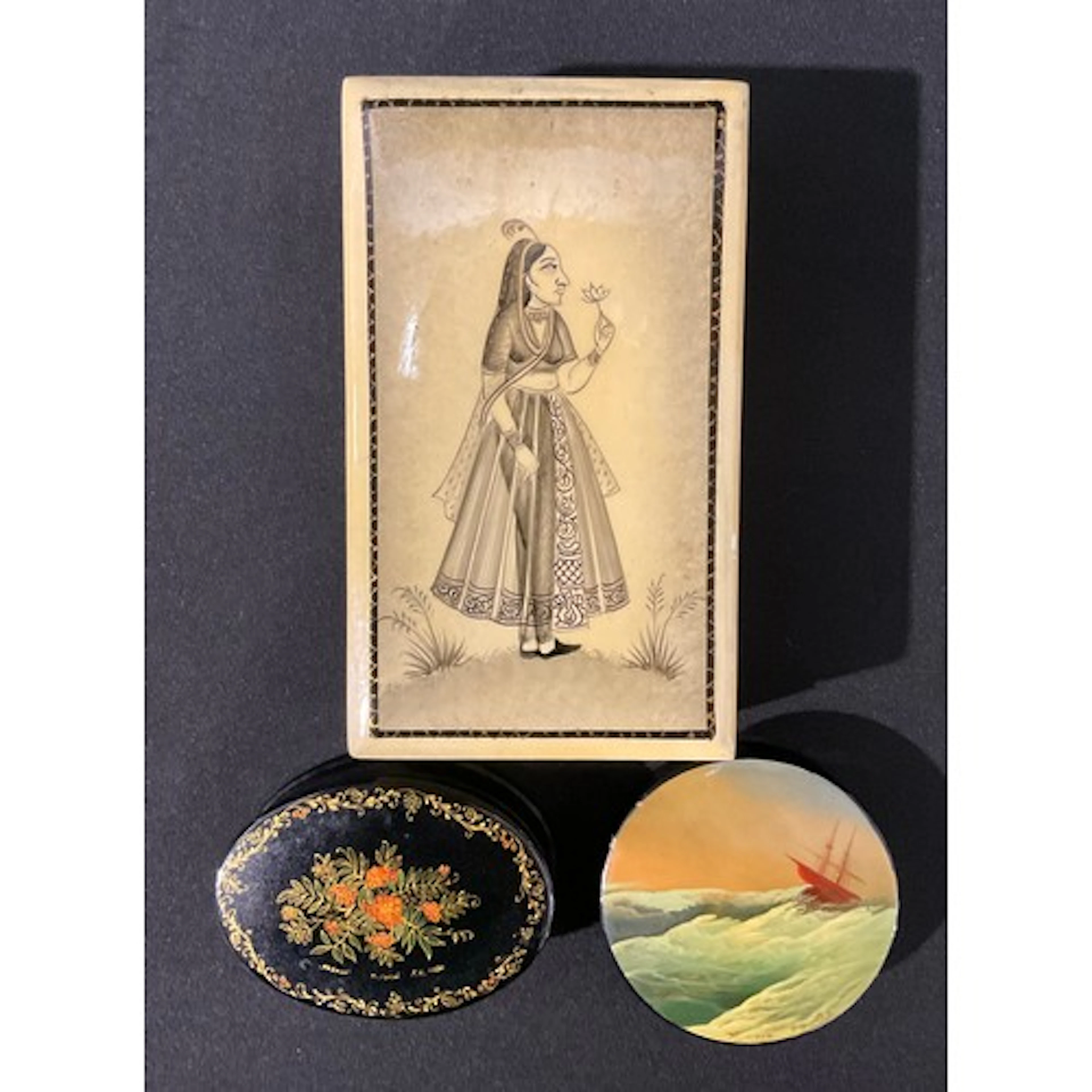 A rounded Russian lacquered box, depicting a ship in rough s...