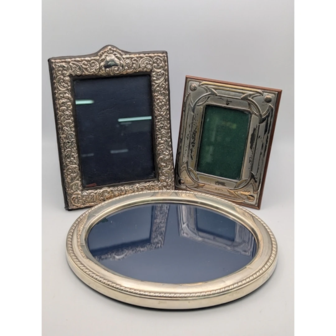 Three silver fronted photograph frames, one in oval form, ha...