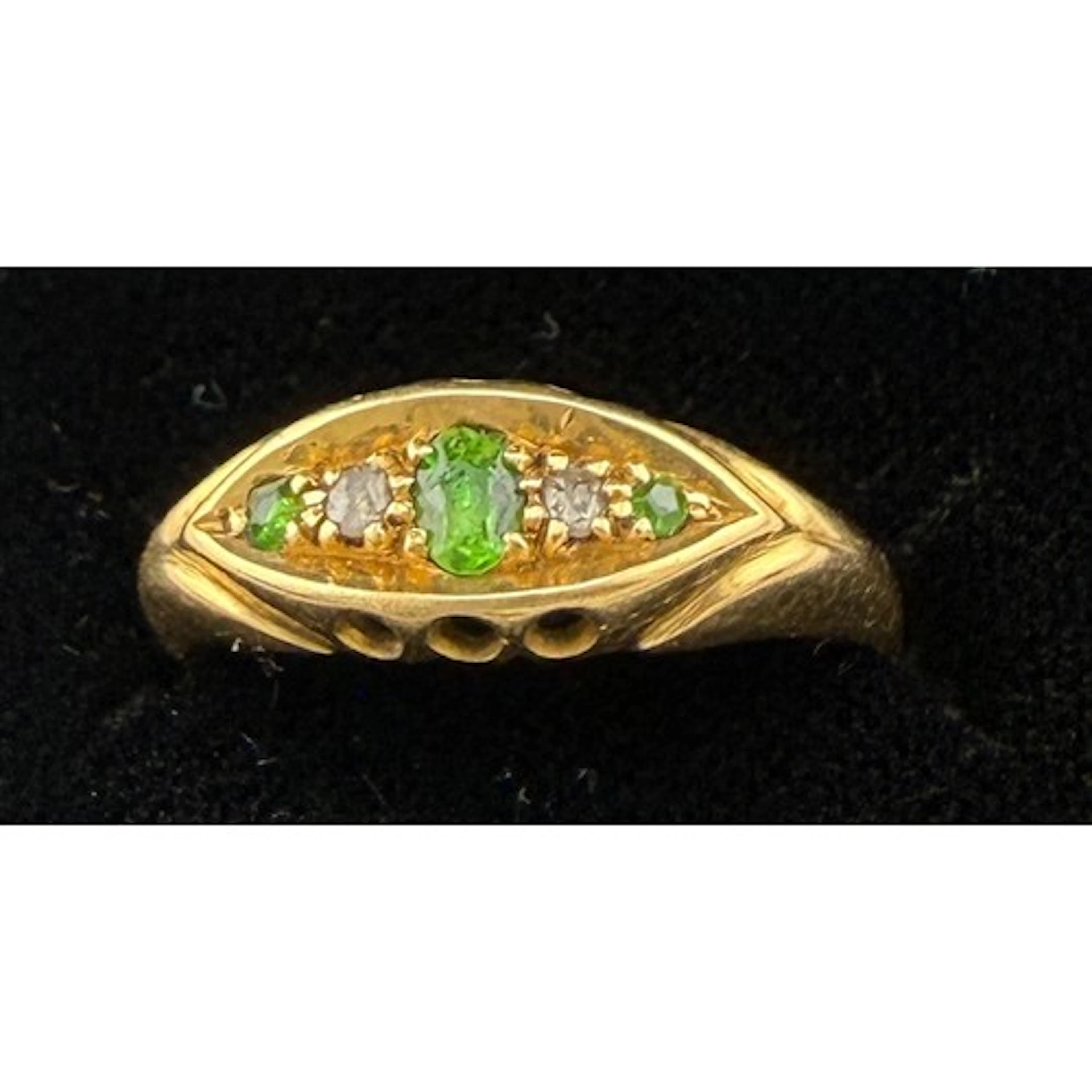 A Victorian 18 carat gold ring set with emeralds and diamond...
