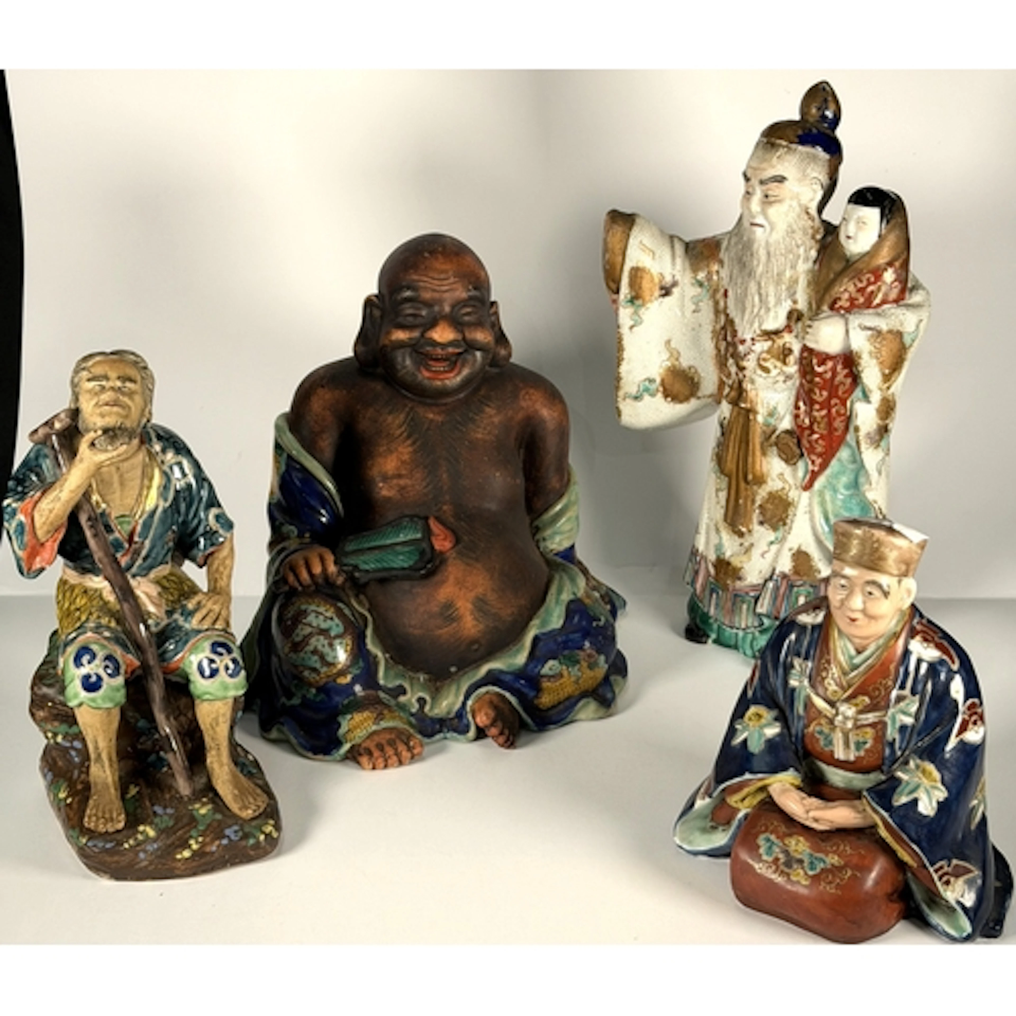 A Chinese ceramic figure of Ho Tai/Laughing Buddha with dark...