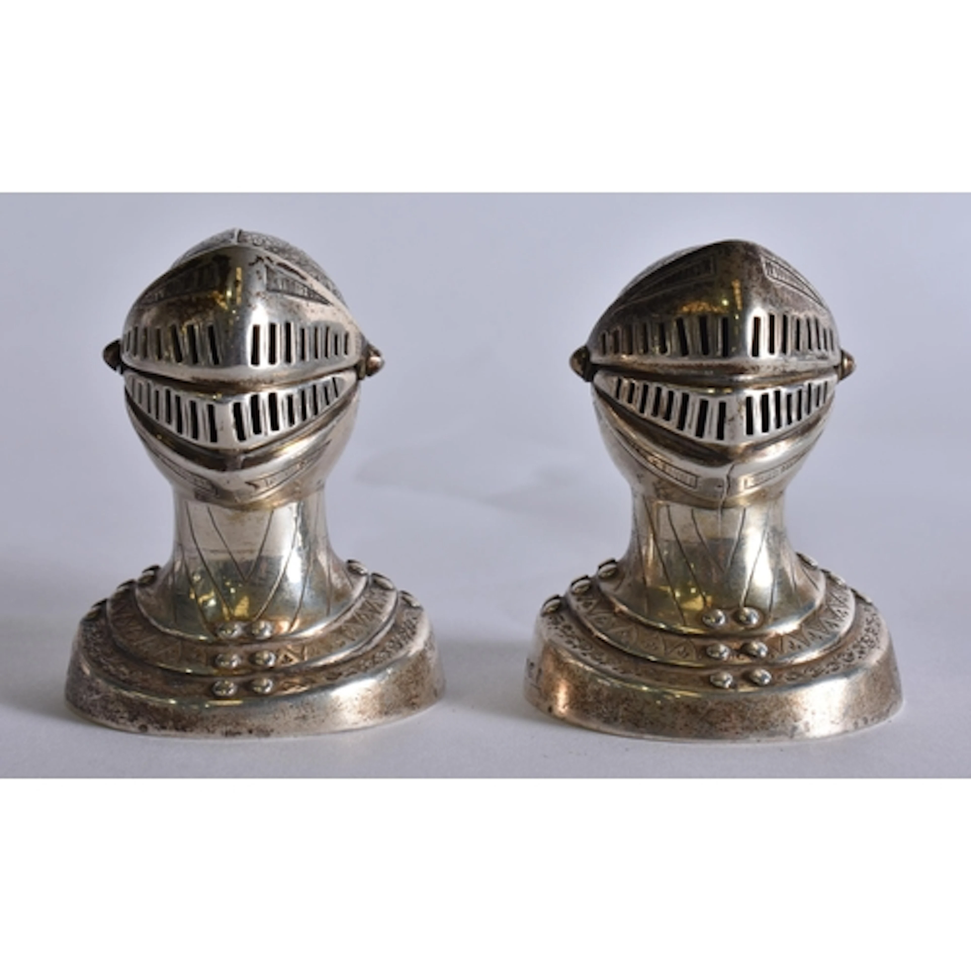 Two Victorian Novelty Pepper Pots in the form of Knights Hea...