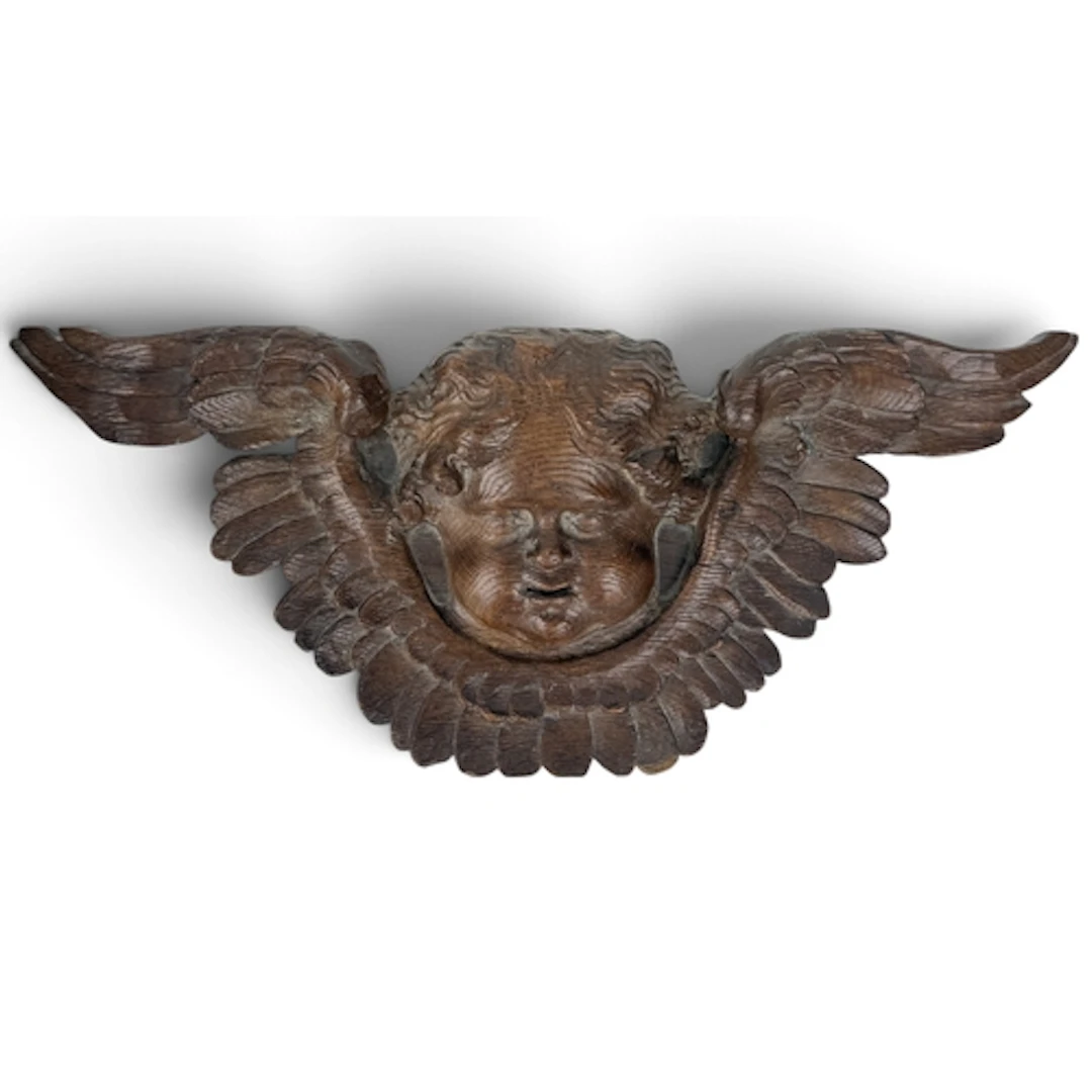 AN 18TH CENTURY CARVED OAK CUPID HEAD WITH WINGS 53cm W...