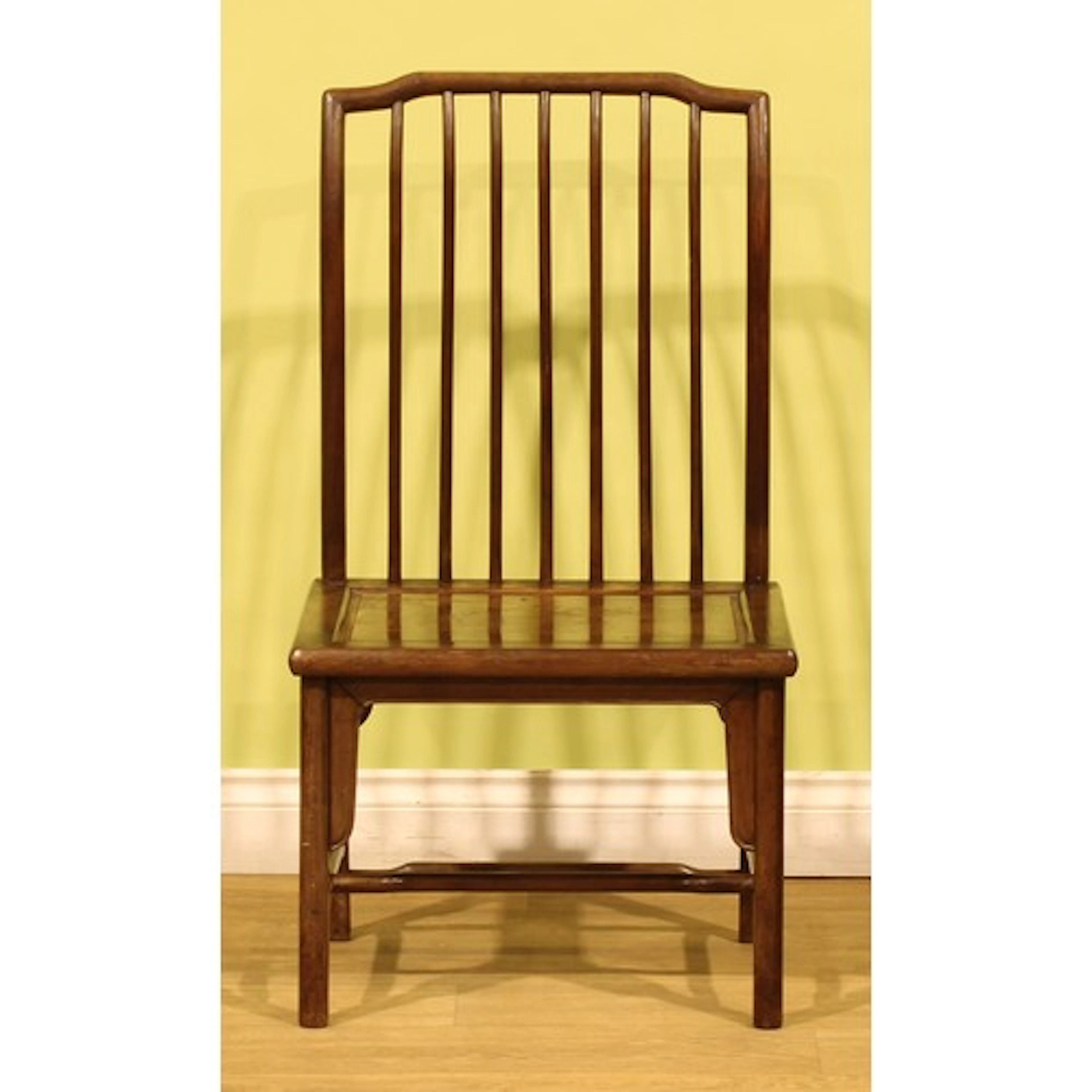 A Chinese hardwood chair, slightly curved back, panel seat, ...