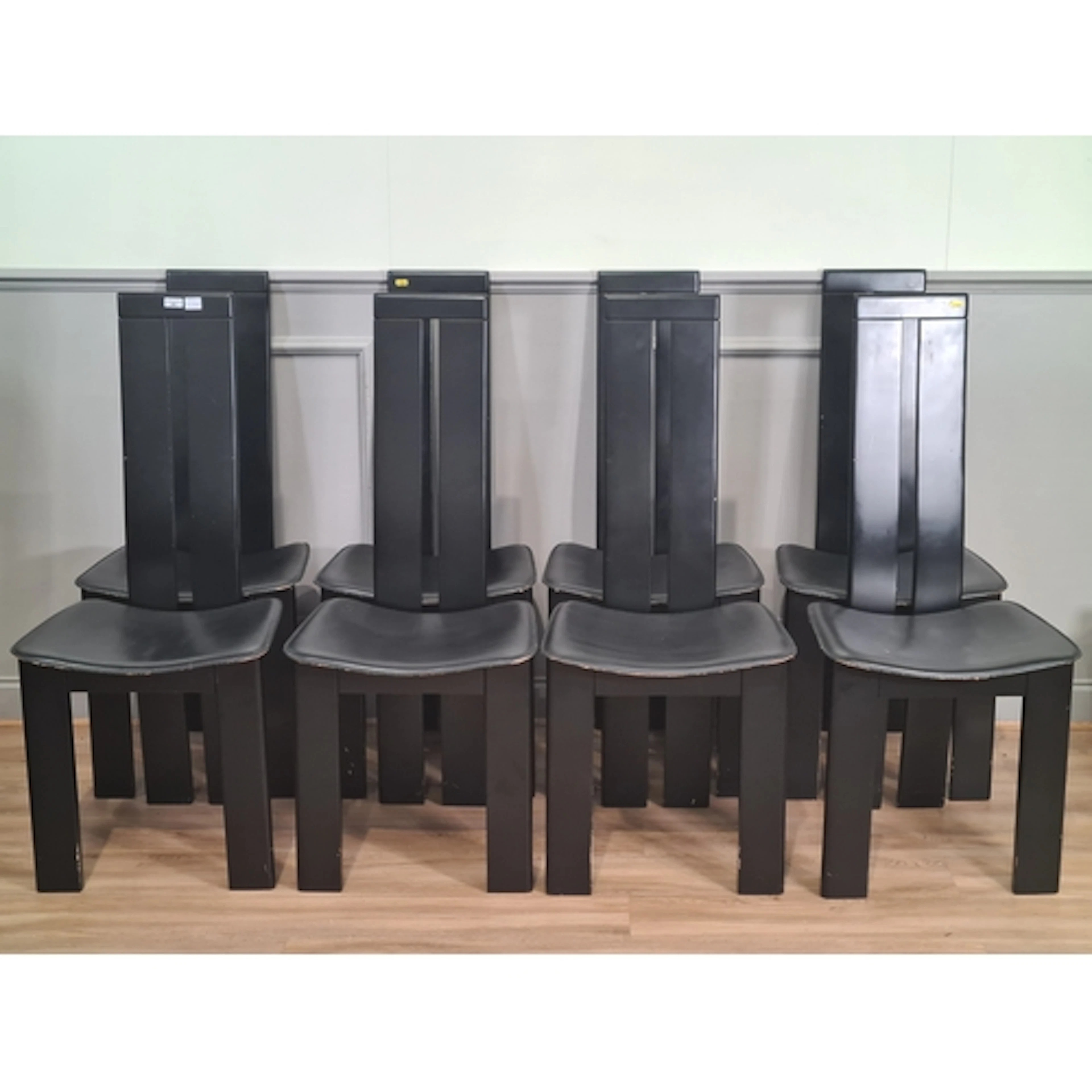 A clear glass Dining Table and eight Habitat black high back...