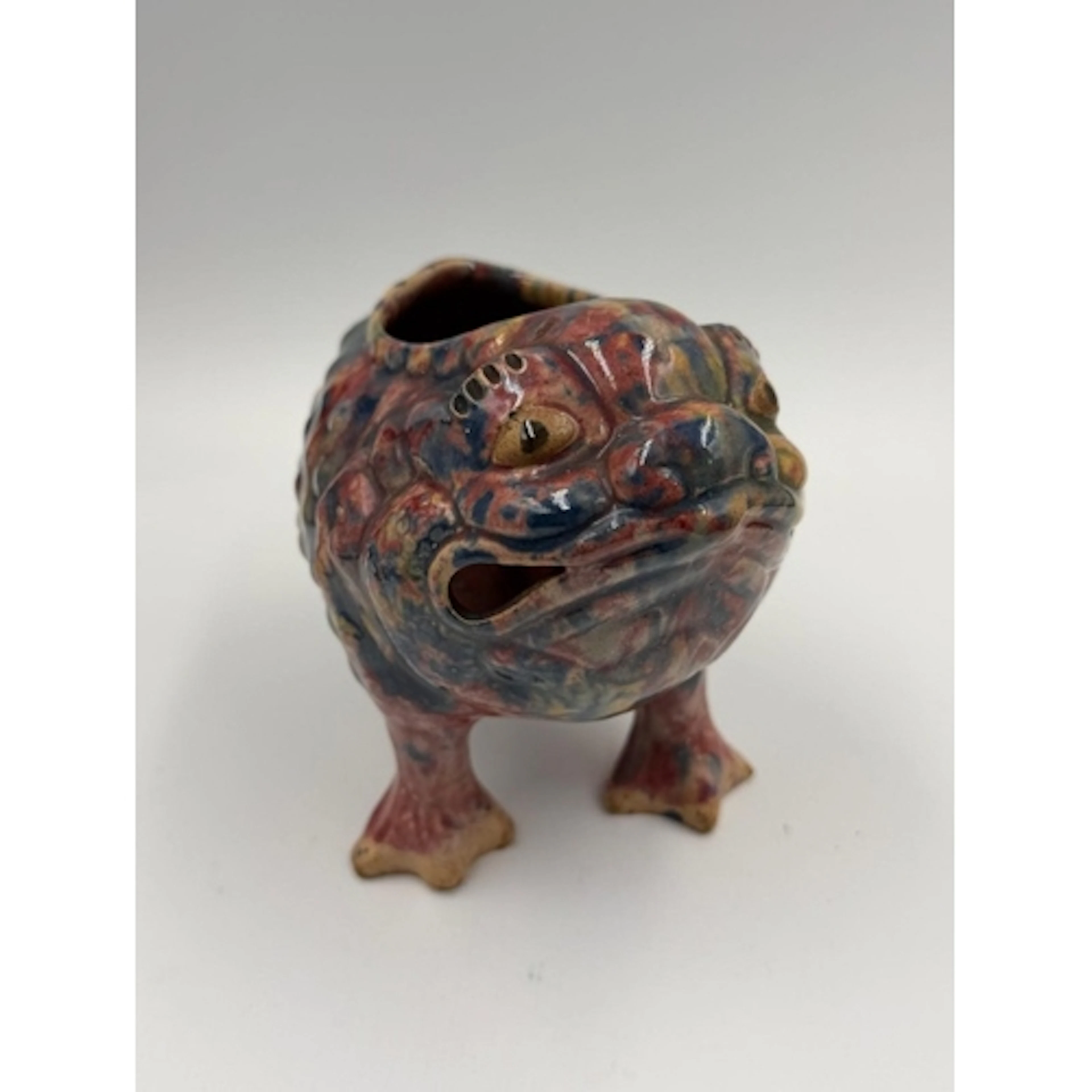 A Dunmore pottery grotesque toad or frog on four feet in mut...