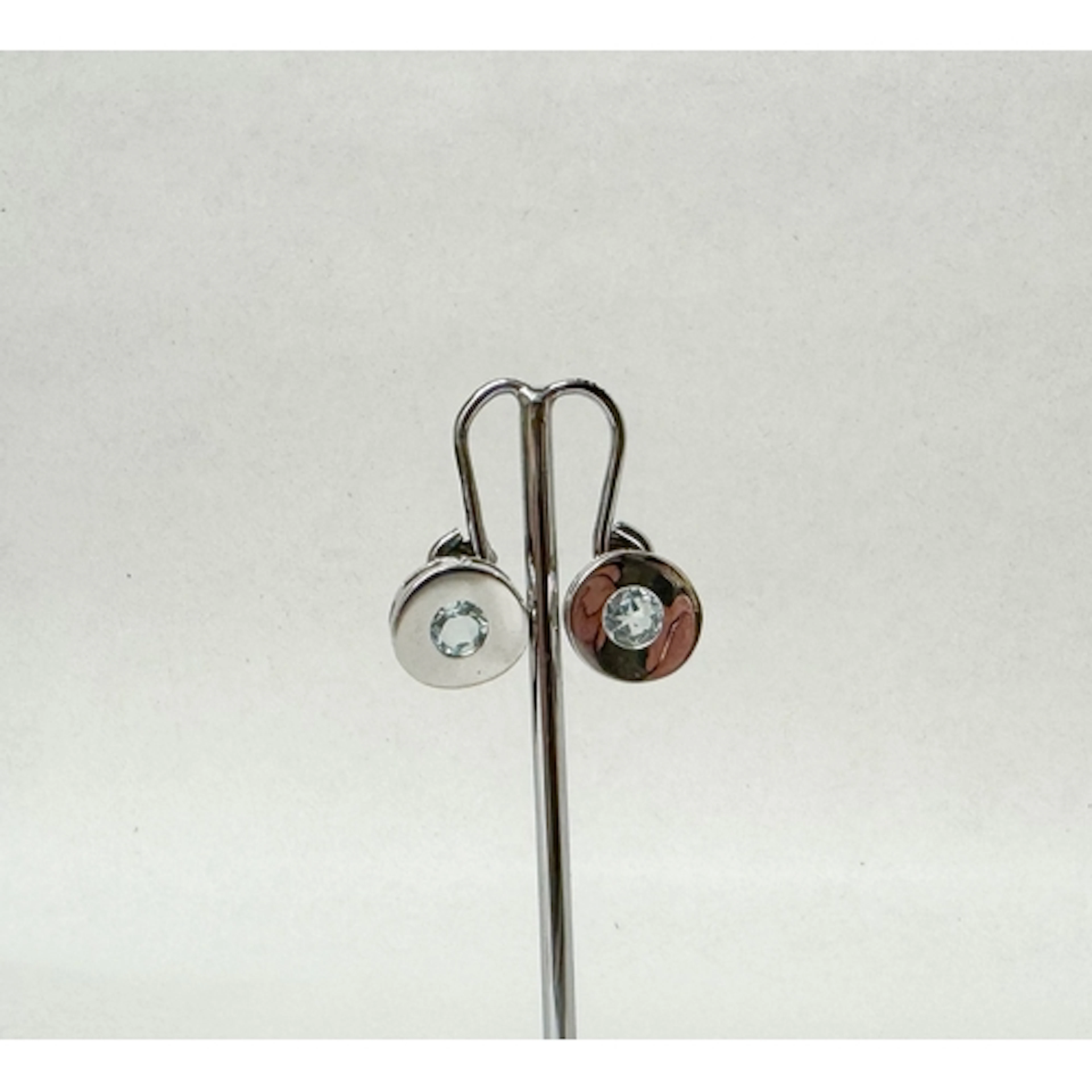 A pair of modern 9ct white gold circular ear studs, set with...