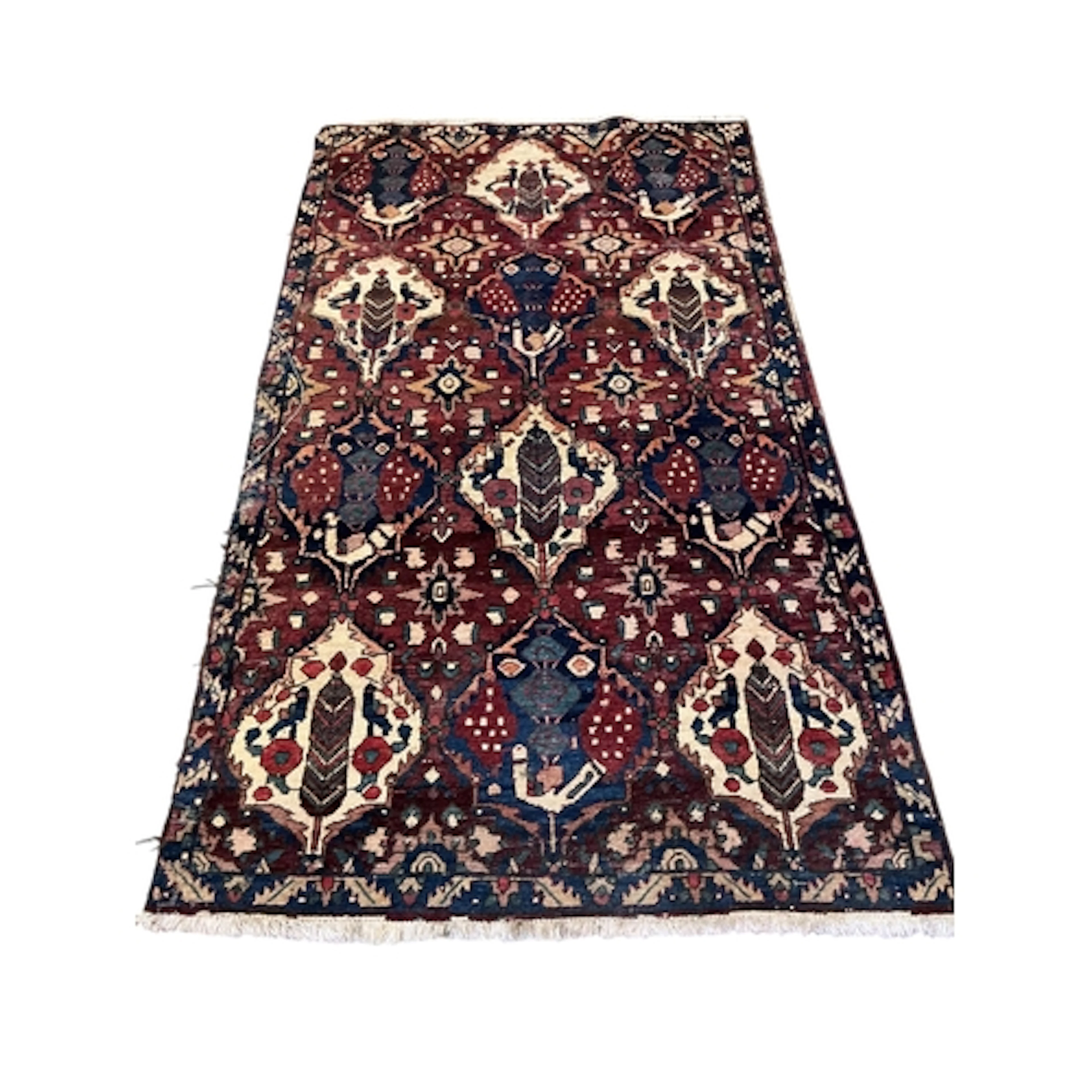 A Bakhtiari red ground rug woven with stylized bird and flor...