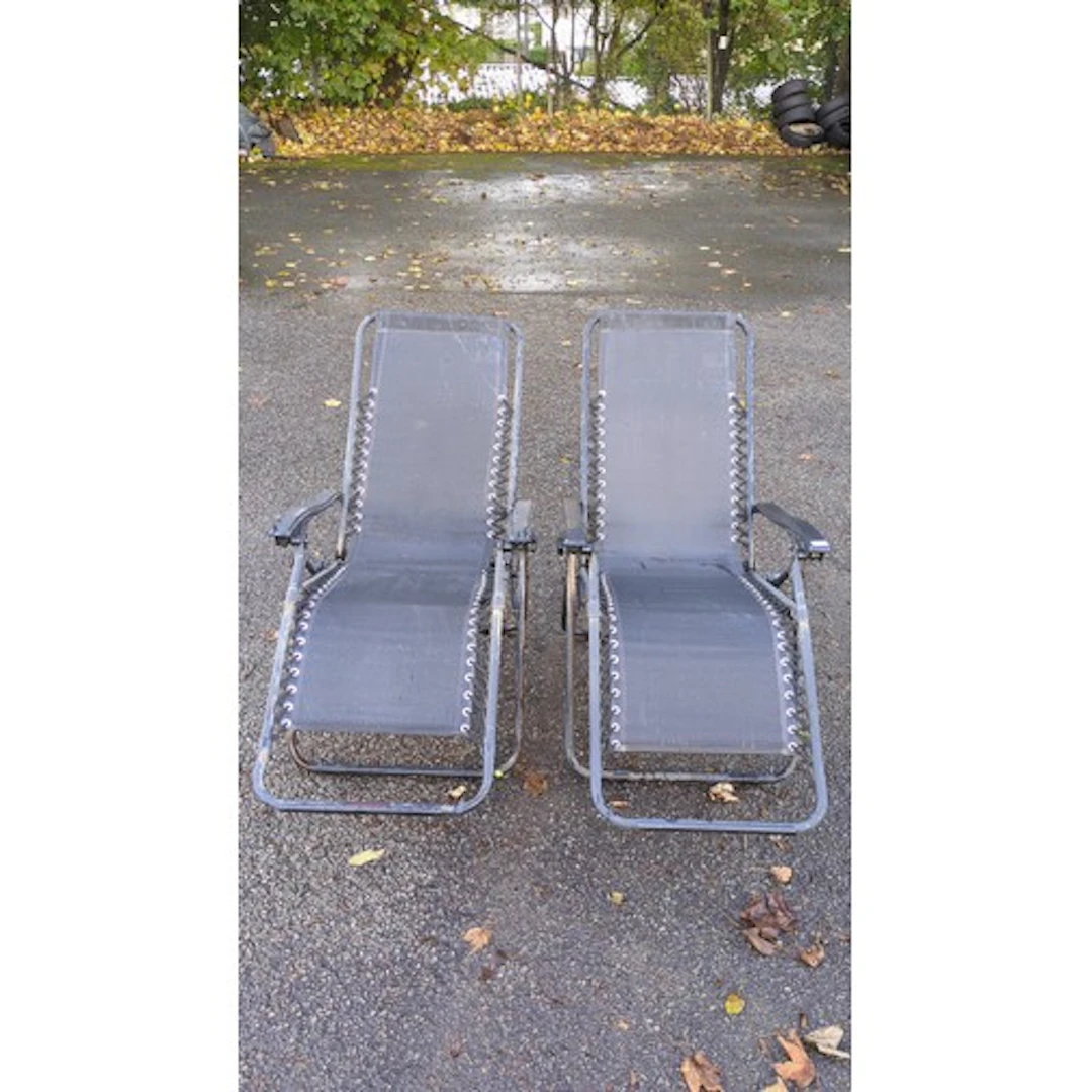 A pair of reclining garden loungers with black fabric sling ...