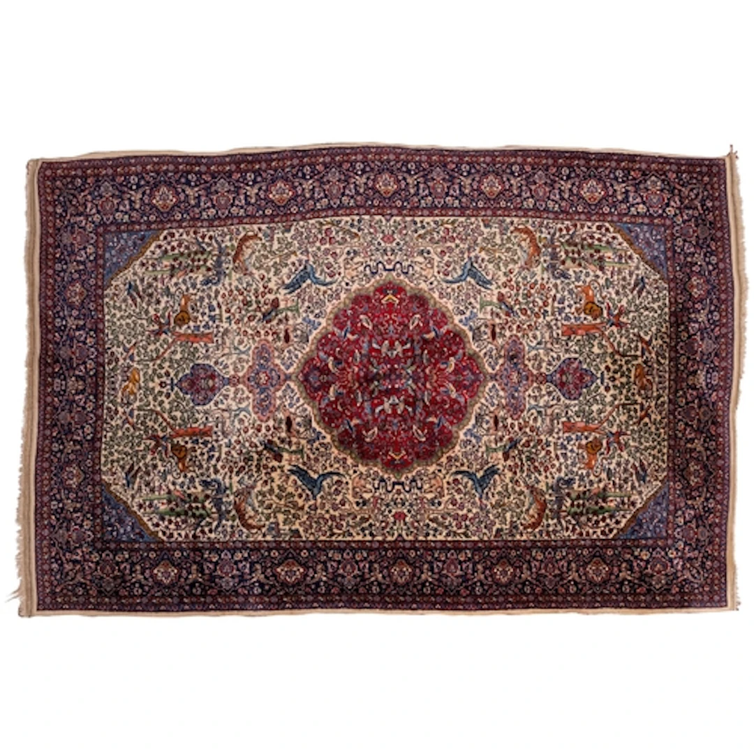 An Indo Persian rug, the ivory field with a central wine car...