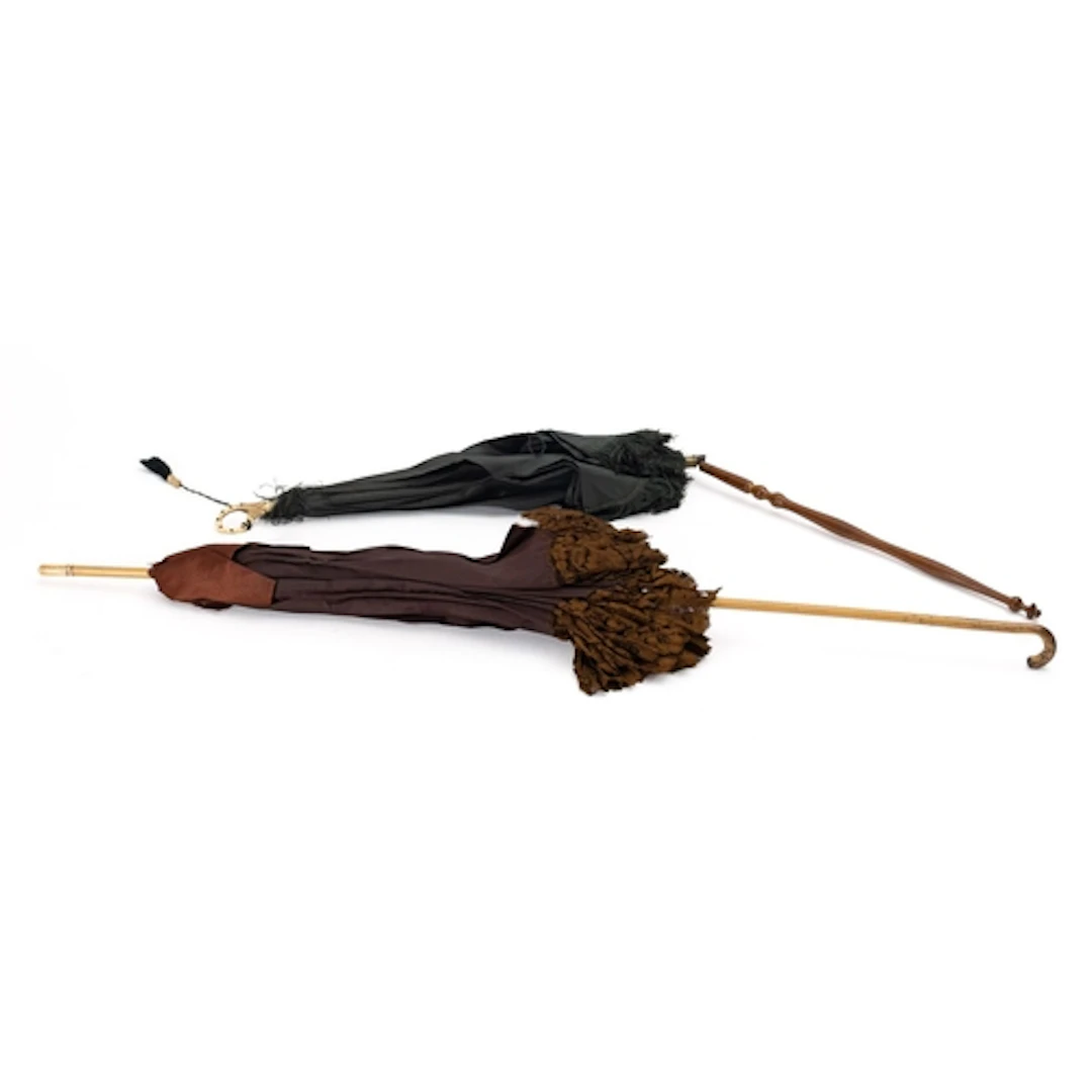 A late Victorian/ early Edwardian brown silk parasol, with b...