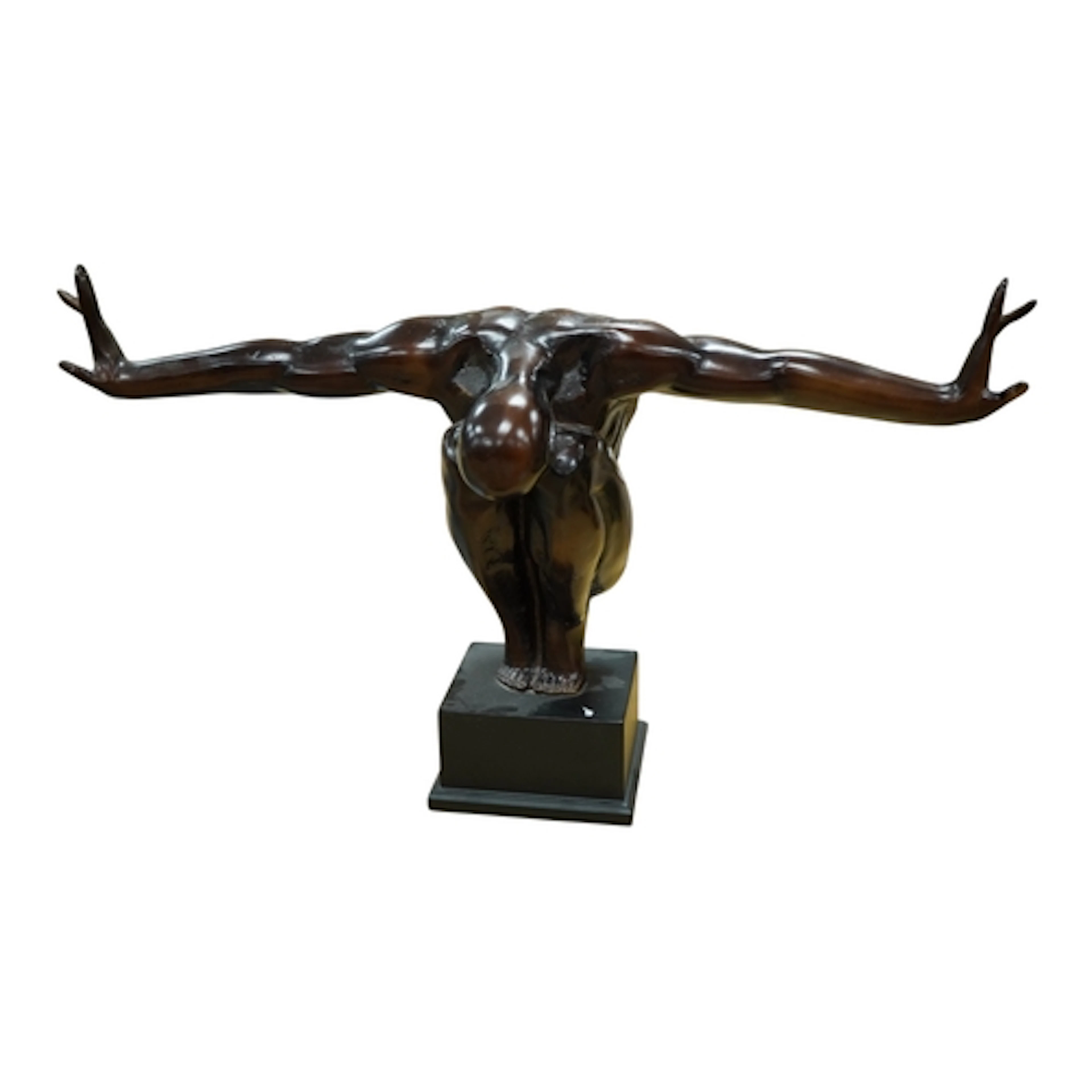 A bronzed statue of a nude figure crouching, on plinth, tota...