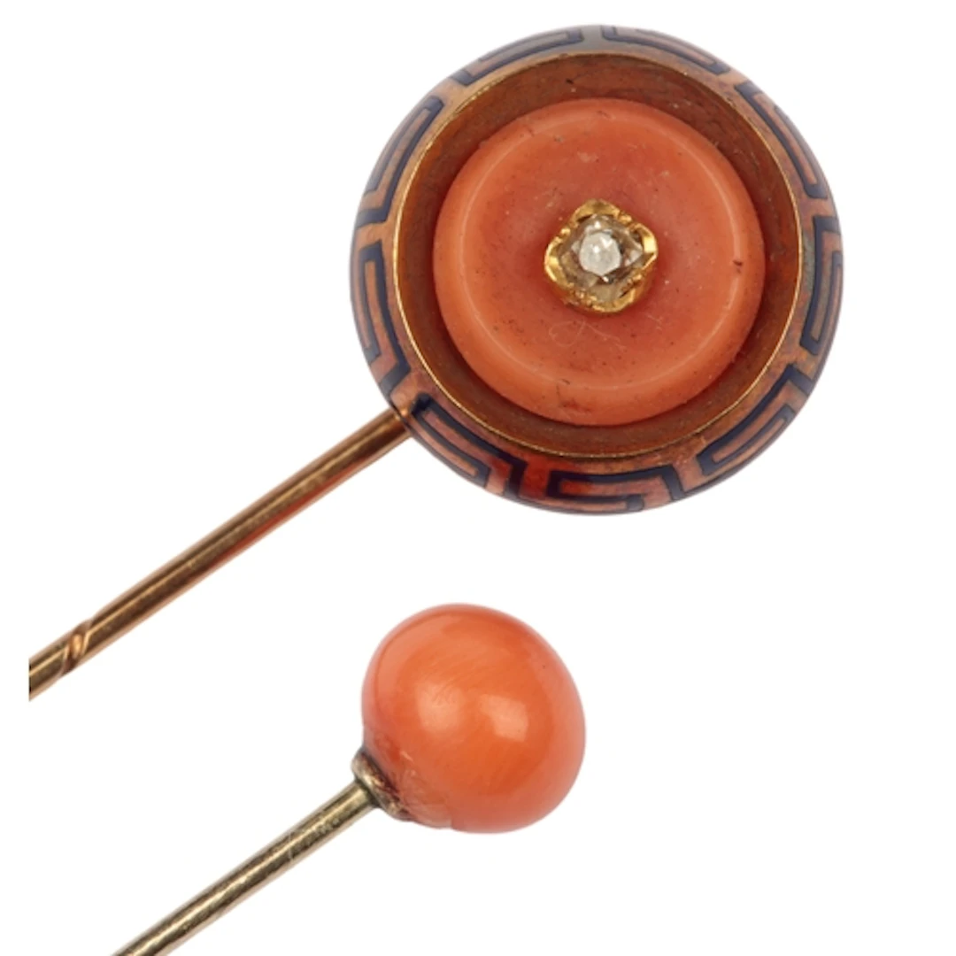 Two coral stick pins, late 19th century, one centring on a c...