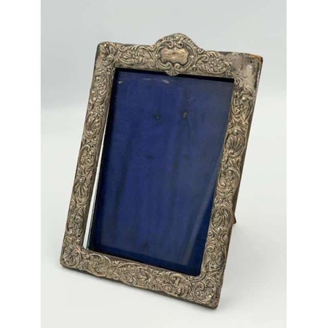 A silver easel backed floriate decorated picture frame hallm...