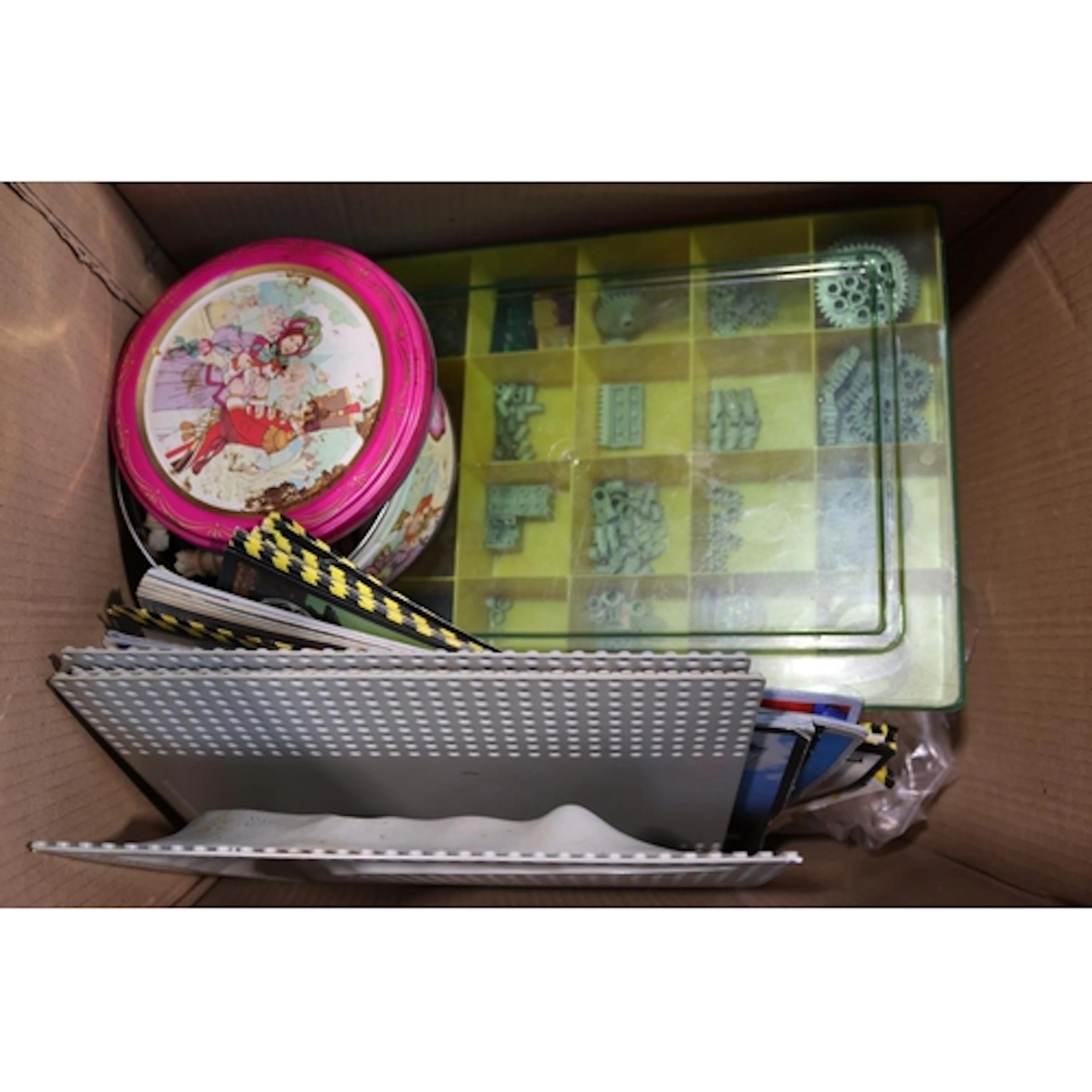 Box of vintage Lego and other building materials.