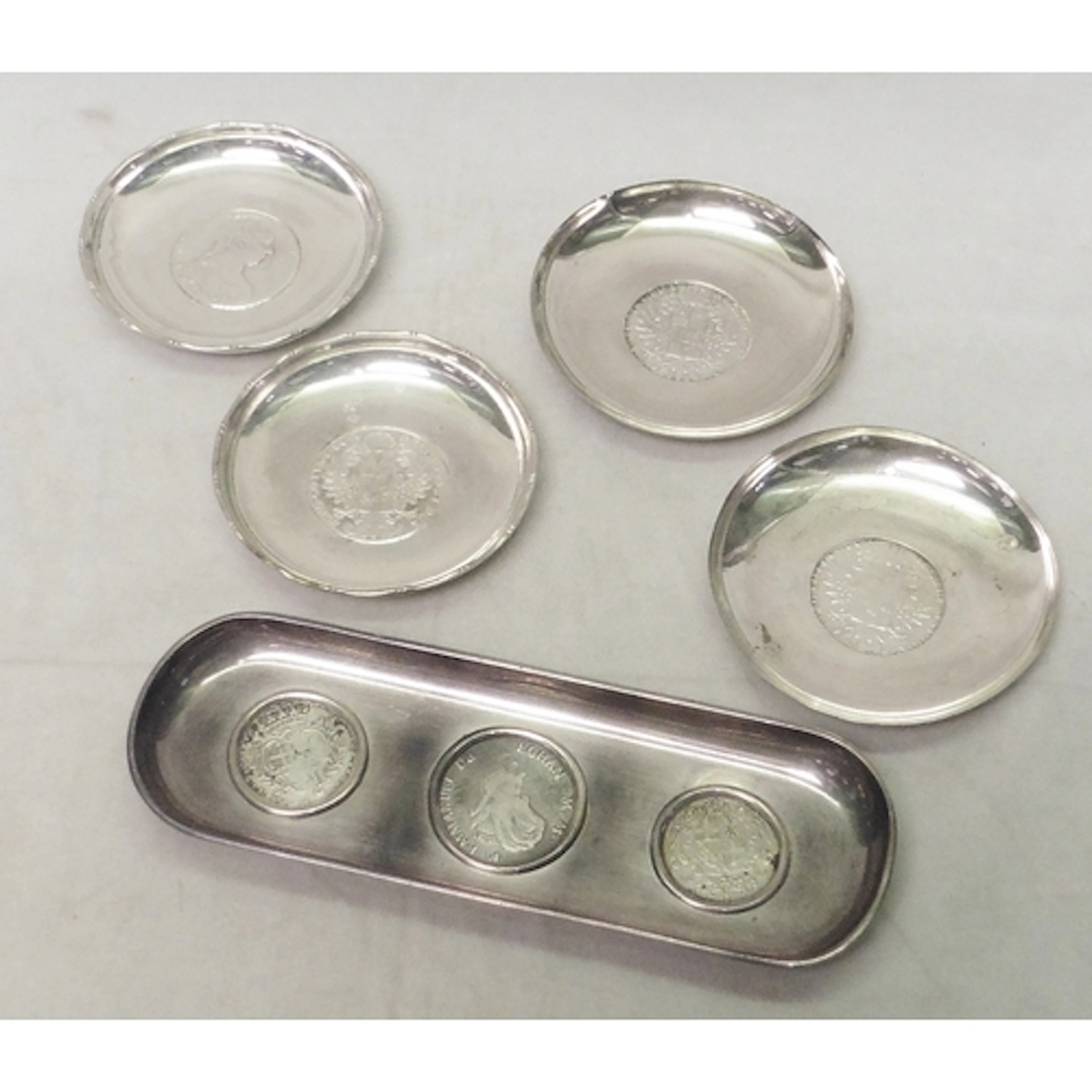 A pair of coin dishes, white metal marked Sterling and inset...
