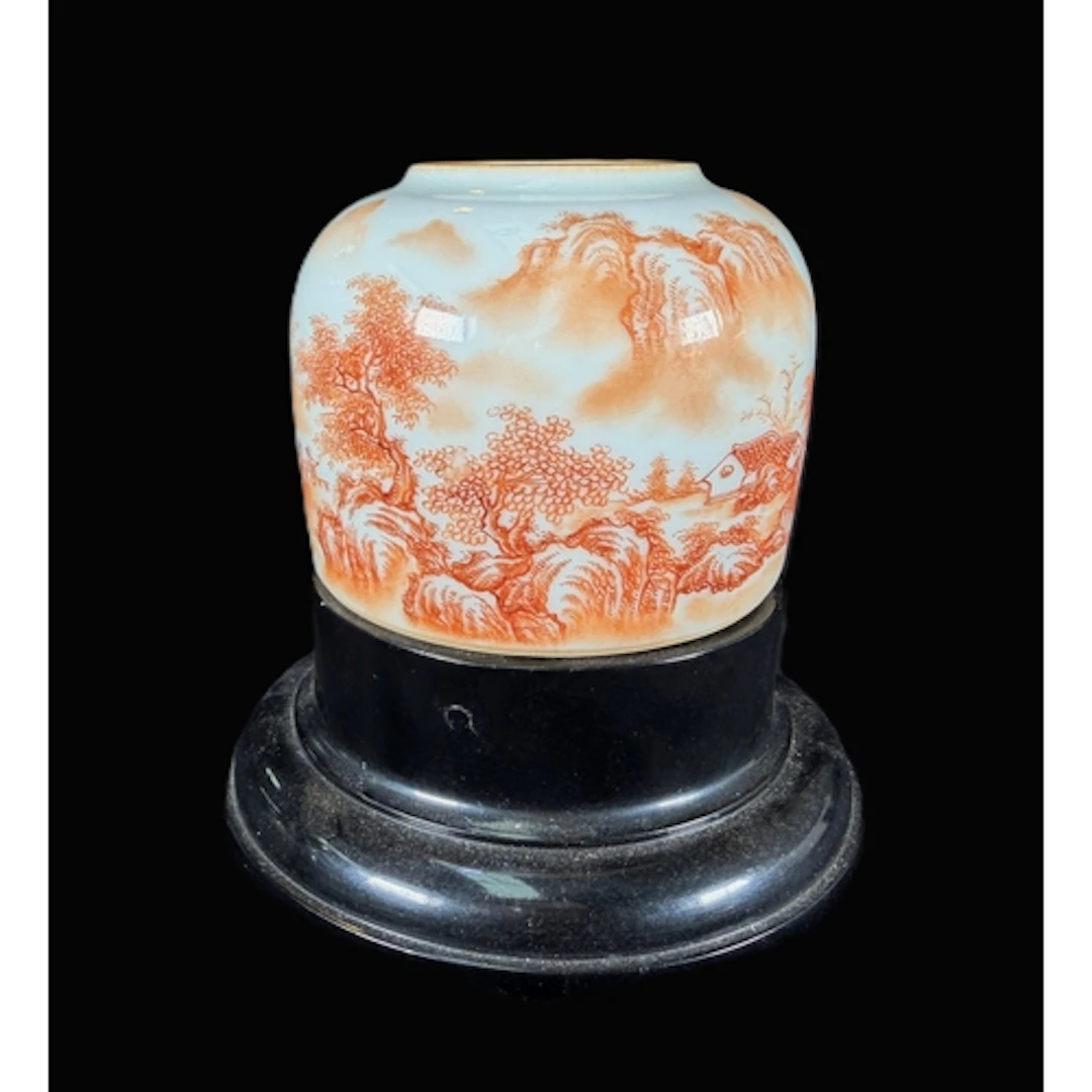 A Chinese porcelain brush pot decorated with iron red lands...