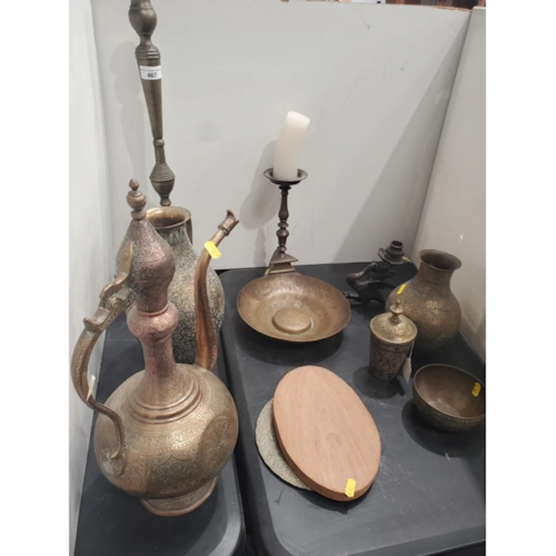 An 18th Century bronze Pricket Candlestick, an Eastern brass...