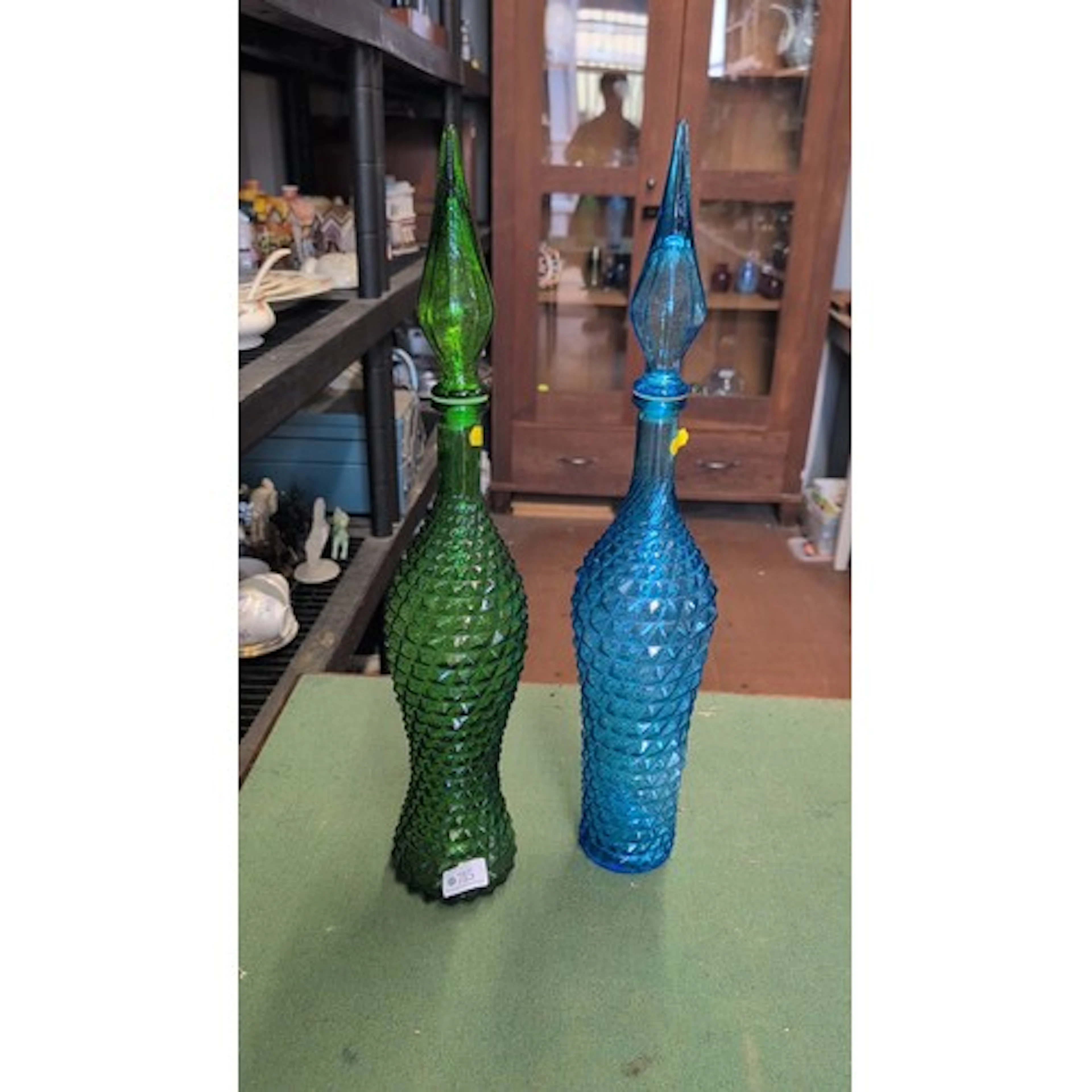 A pair of moulded coloured-glass decanters with stoppers, on...