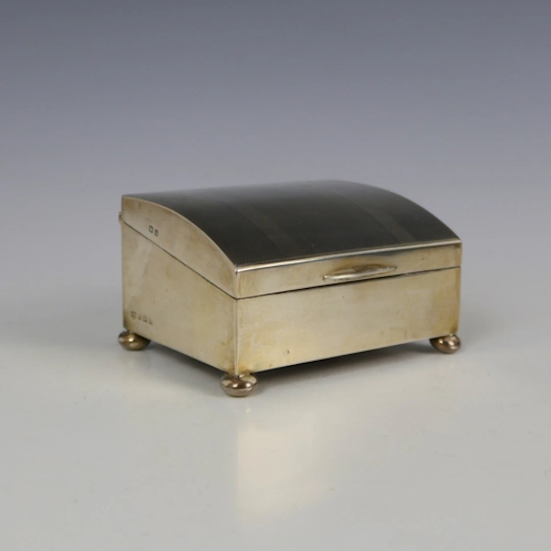 A George V silver mounted cigarette box, S Blanckensee & Son...