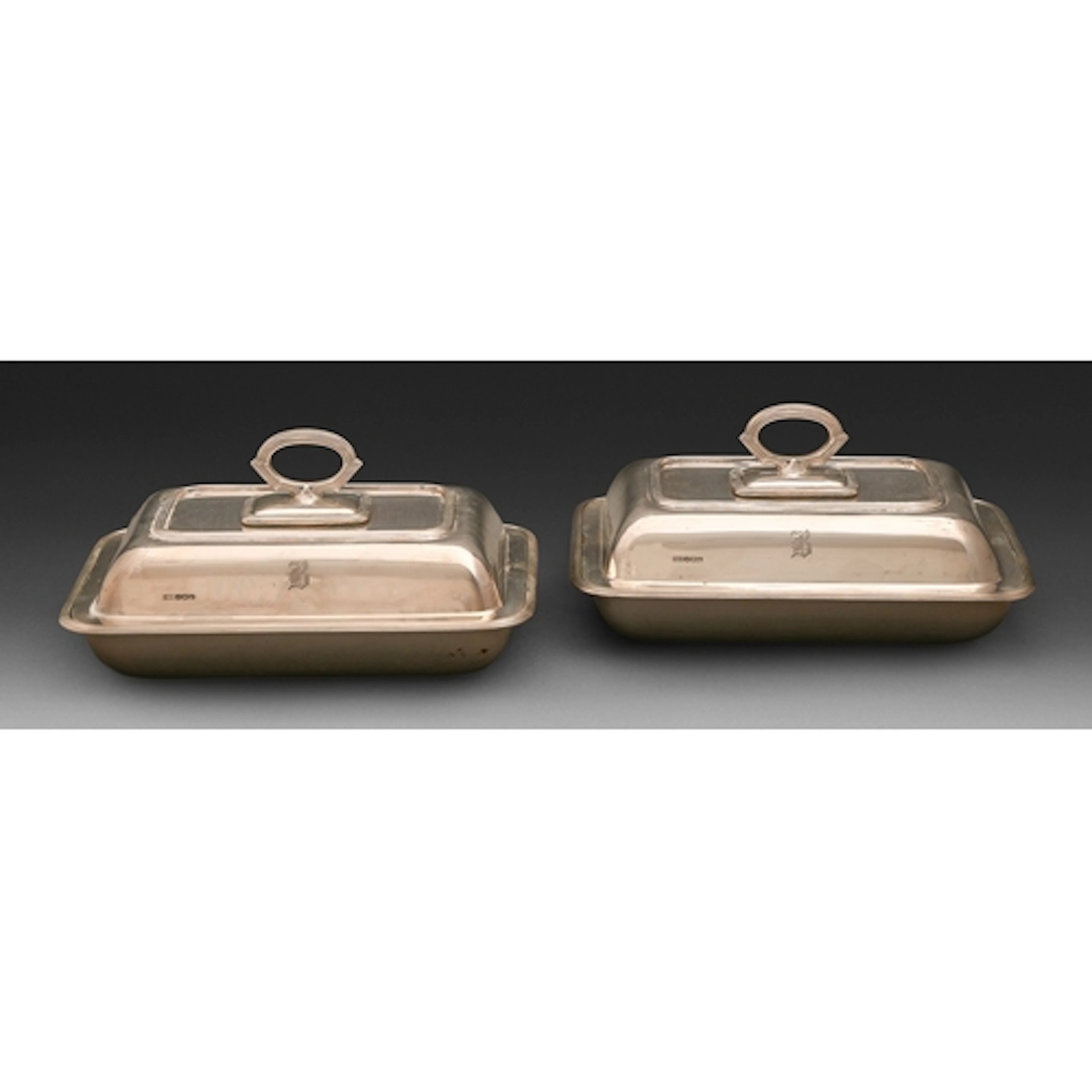 A pair of George VI silver entrée dishes and covers, with re...
