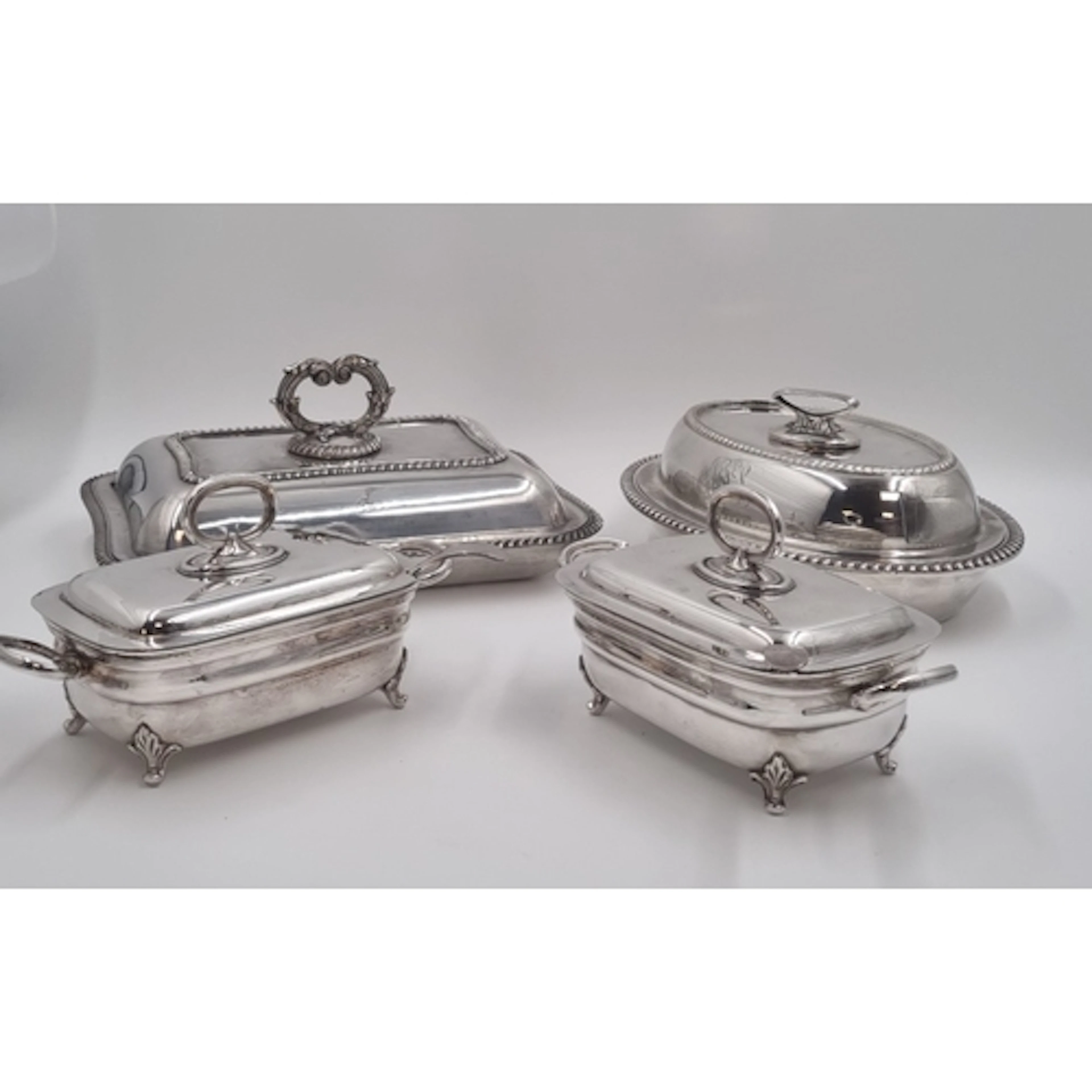 Four assorted silver-plated covered serving dishes, to inclu...