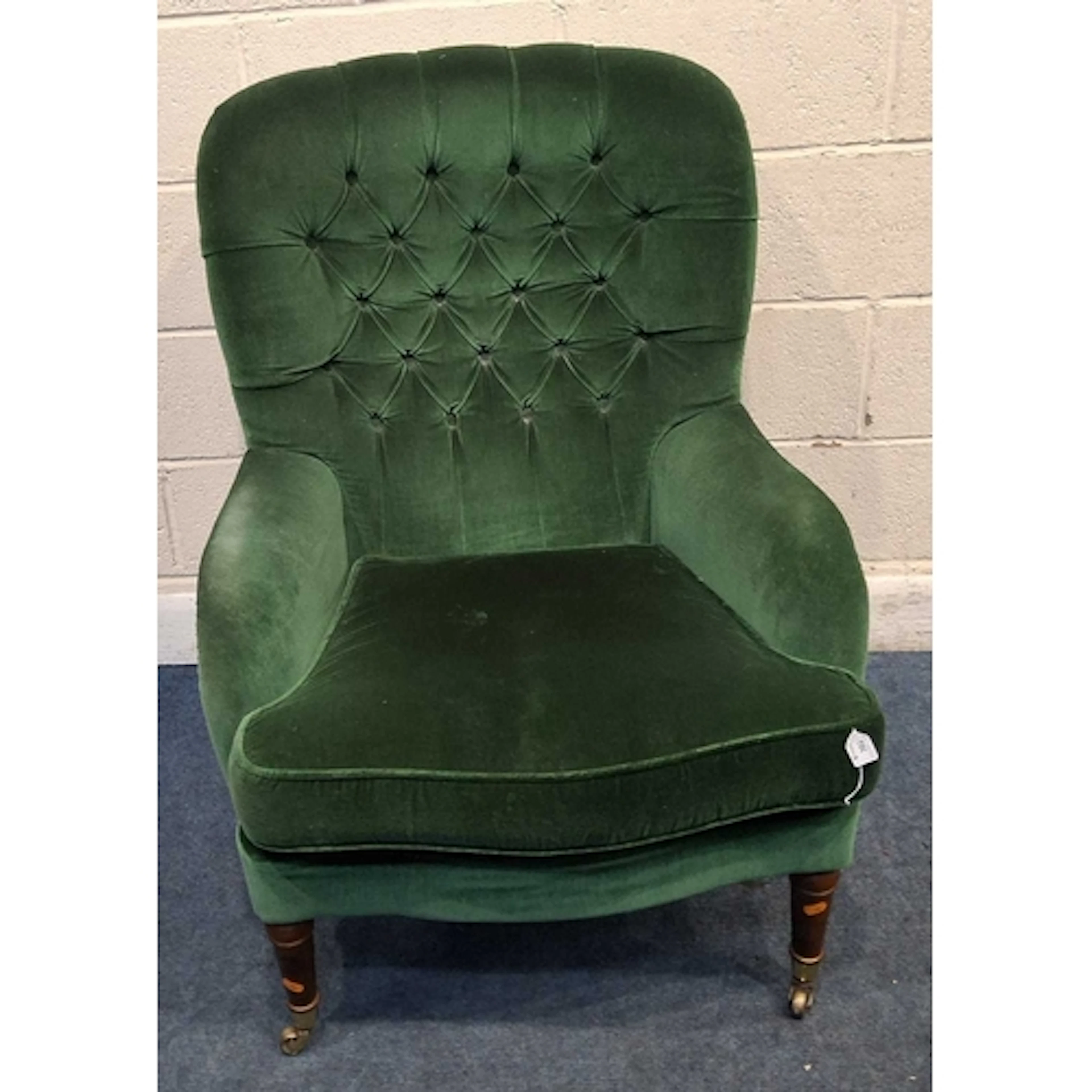 A PARKER KNOLL GREEN FABRIC UPHOLSTERED BUTTON BACK ARMCHAIR...