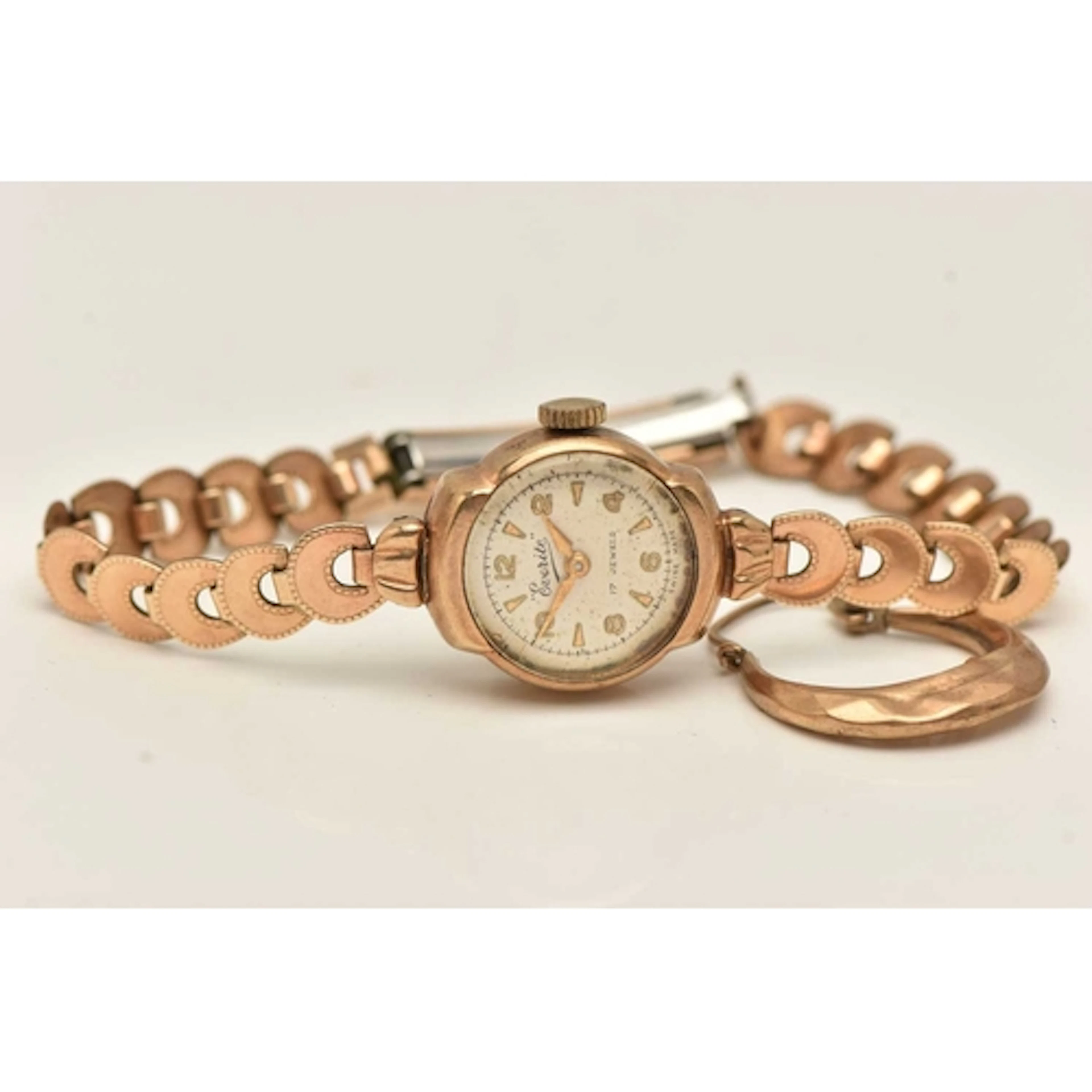 A LADIES 9CT GOLD CASED WRISTWATCH AND A SINGLE HOOP EARRING...