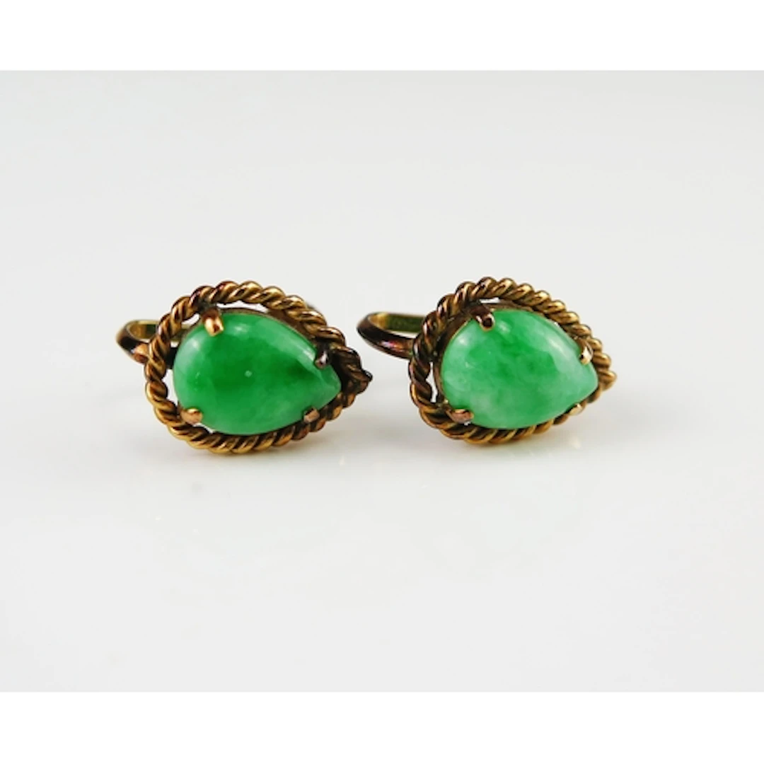 A pair of jade tear drop earrings in 14K yellow gold with sc...
