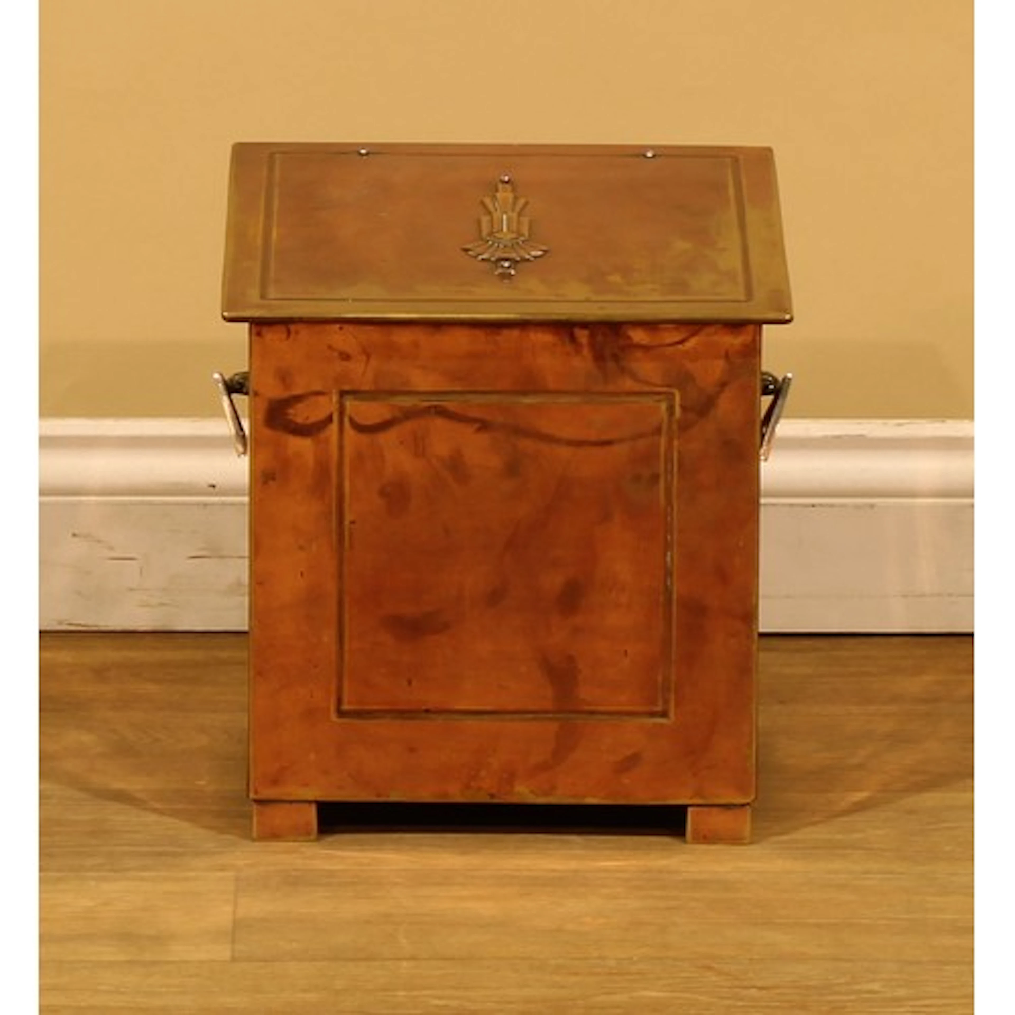 An Art Deco copper rectangular fuel bin, the hinged sloping ...