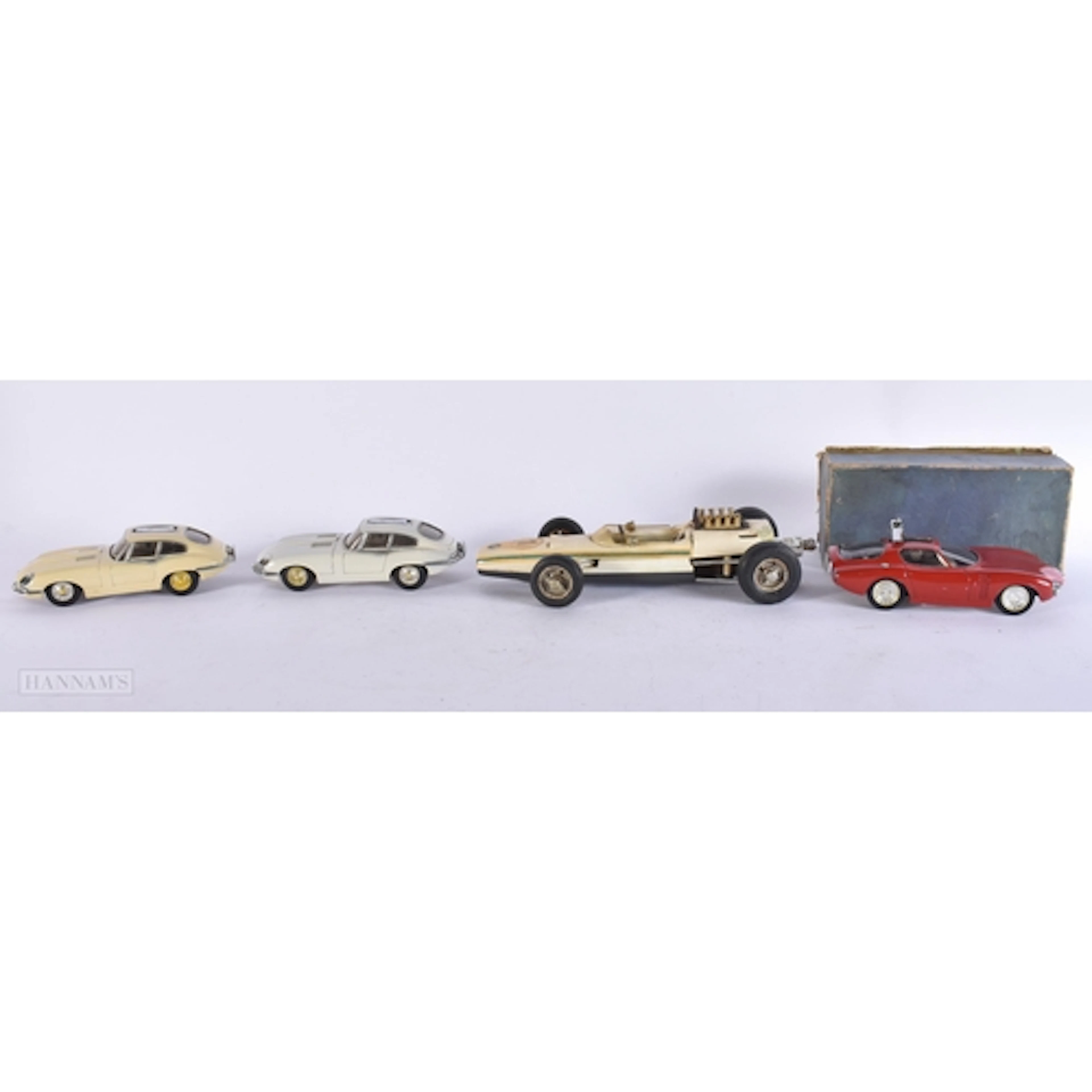FOUR UNUSUAL VINTAGE SPORTS CAR LIGHTERS. Largest 22 cm wide...