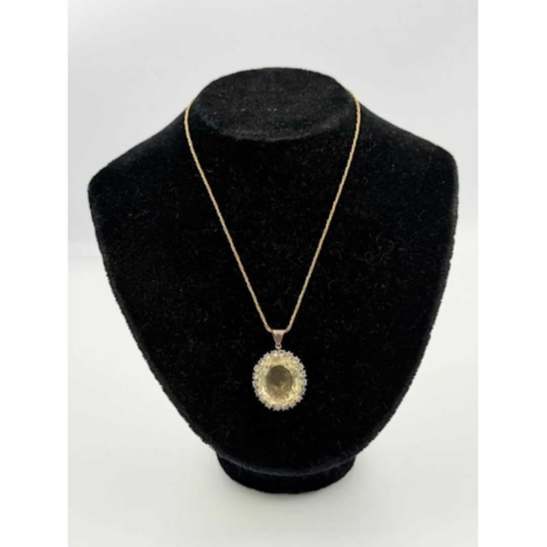 A citrine and diamond pendant on a 14ct gold necklace....