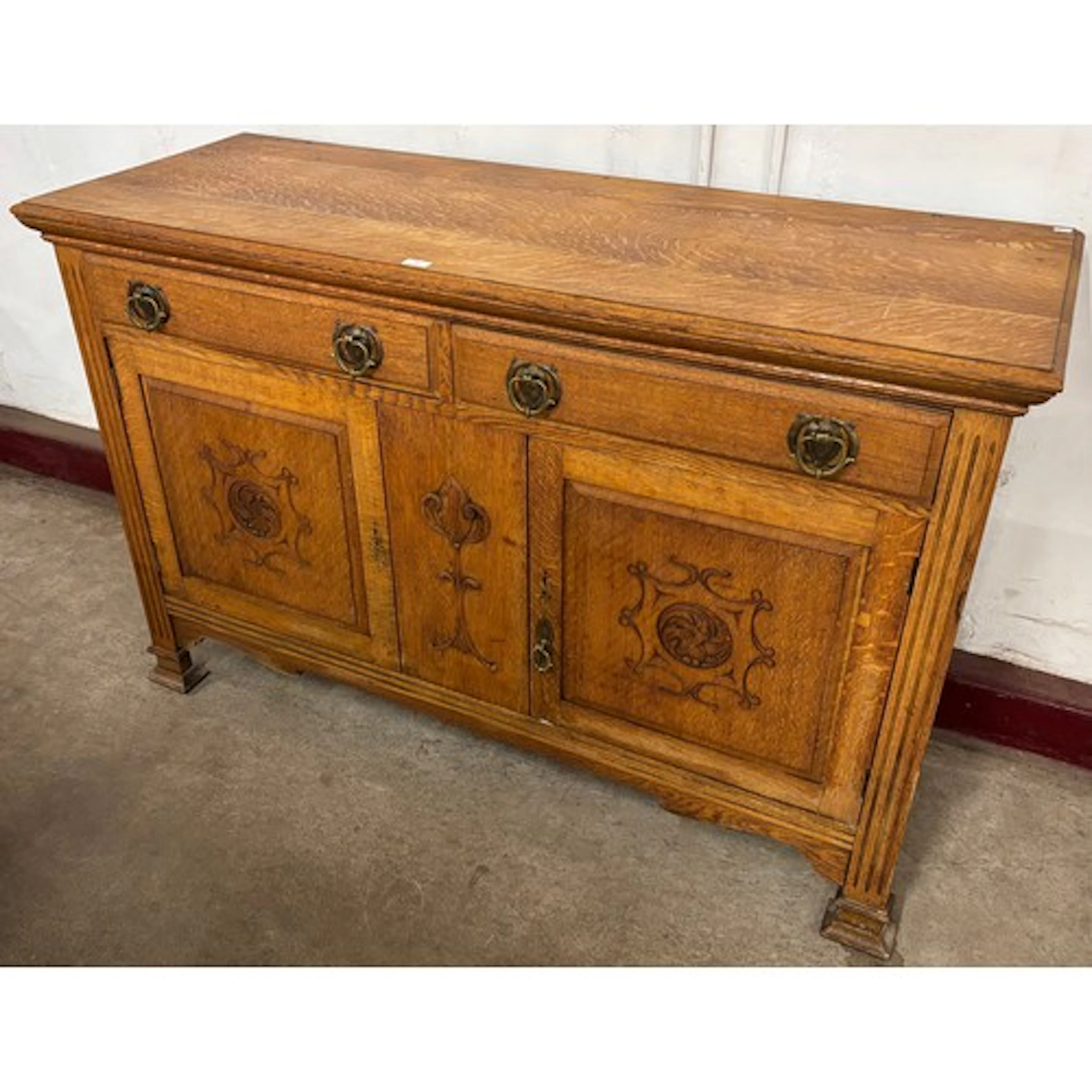 An Arts and Crafts oak sideboard