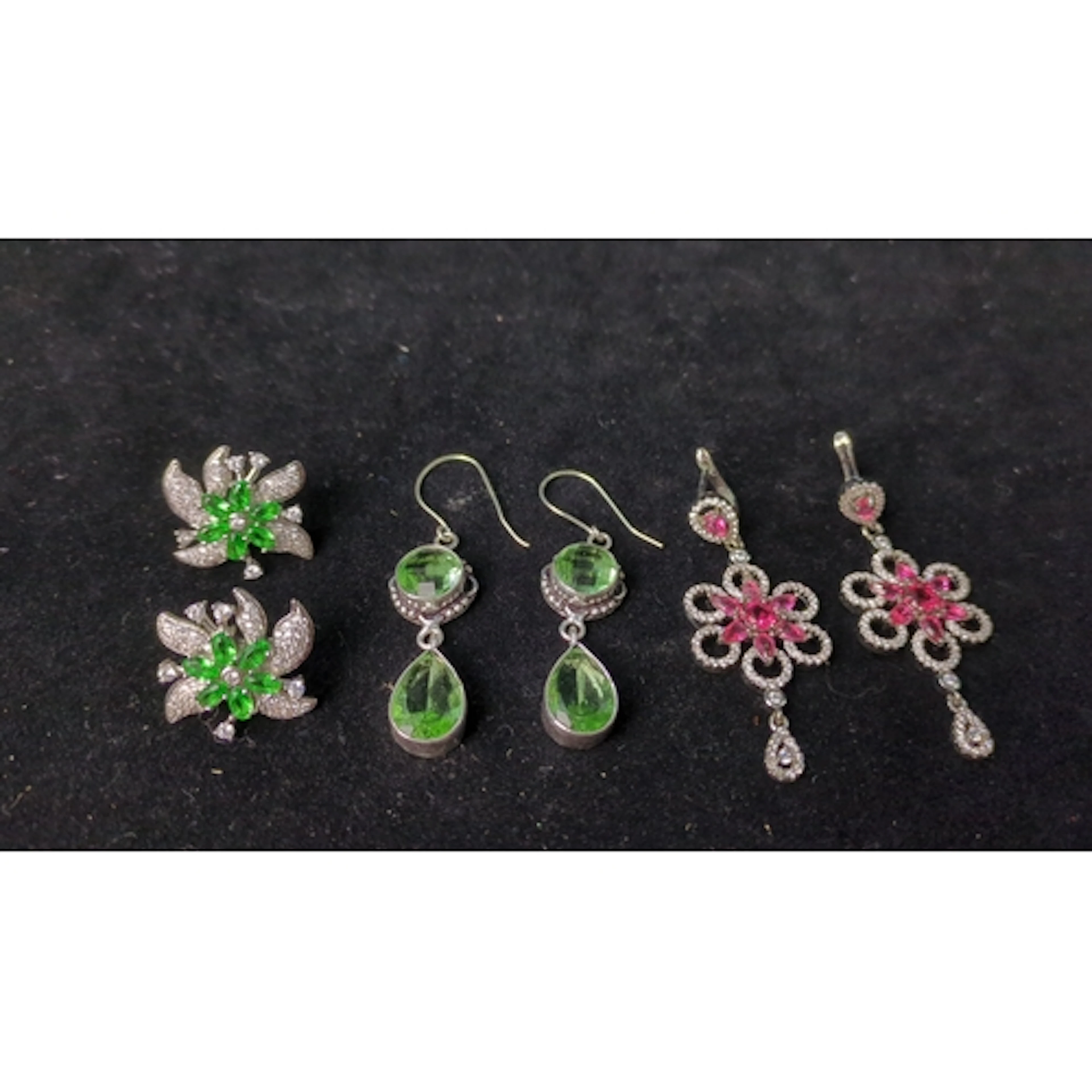 Three pairs of stone-set earrings: green floral studs with f...