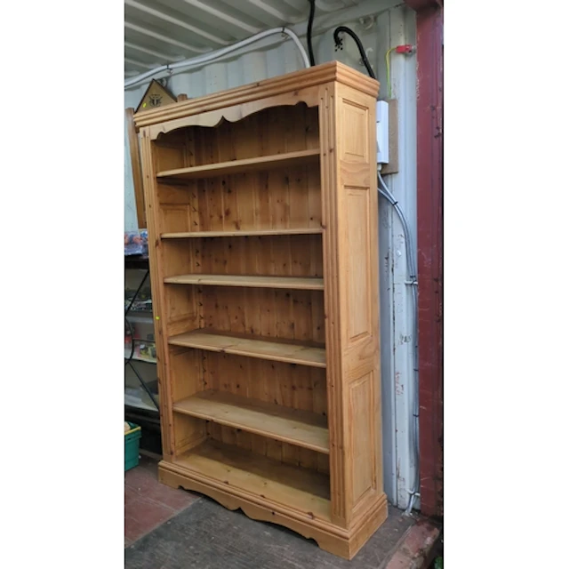 Pine open bookcase with a moulded cornice above a shaped apr...