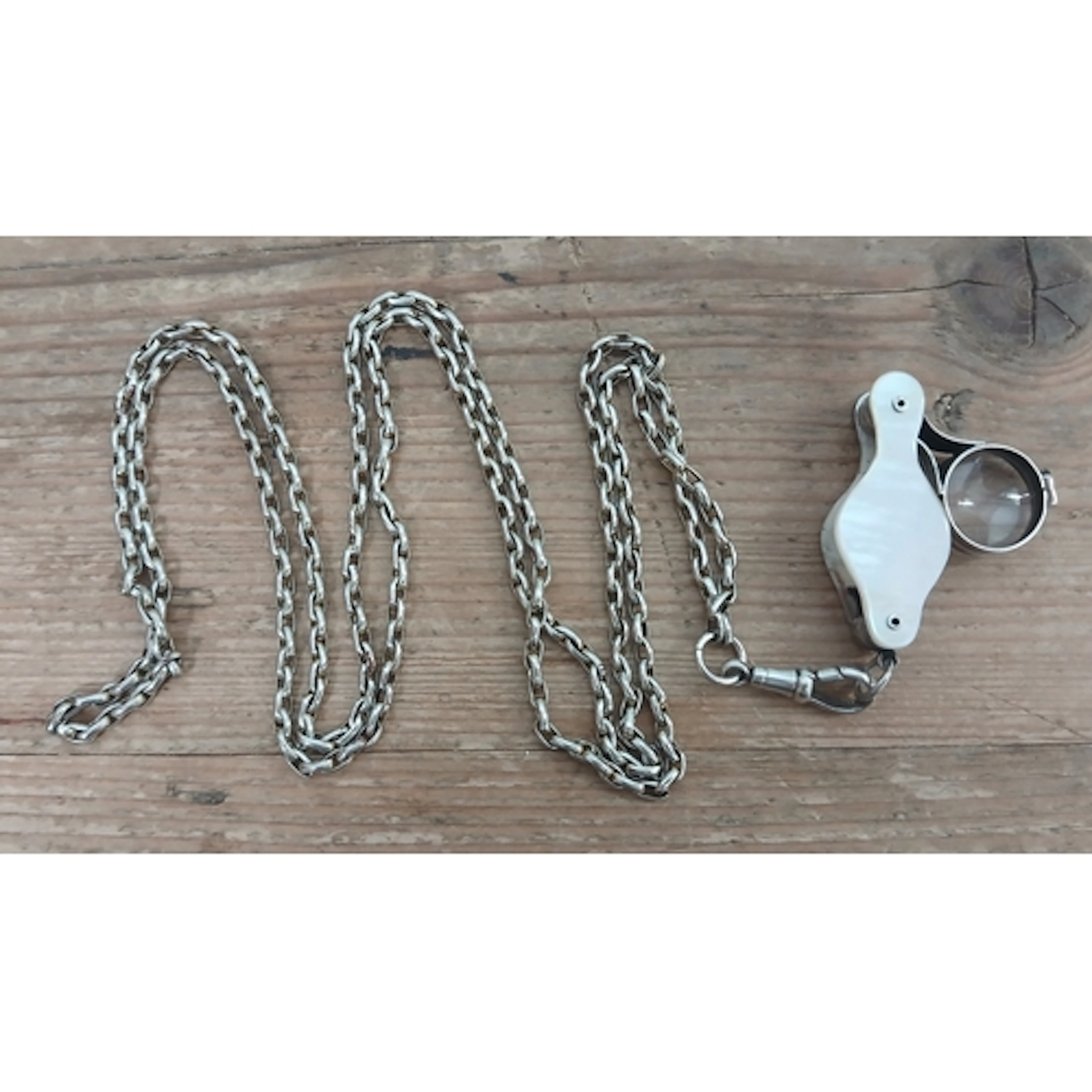 A late Georgian white metal and mother of pearl folding loup...