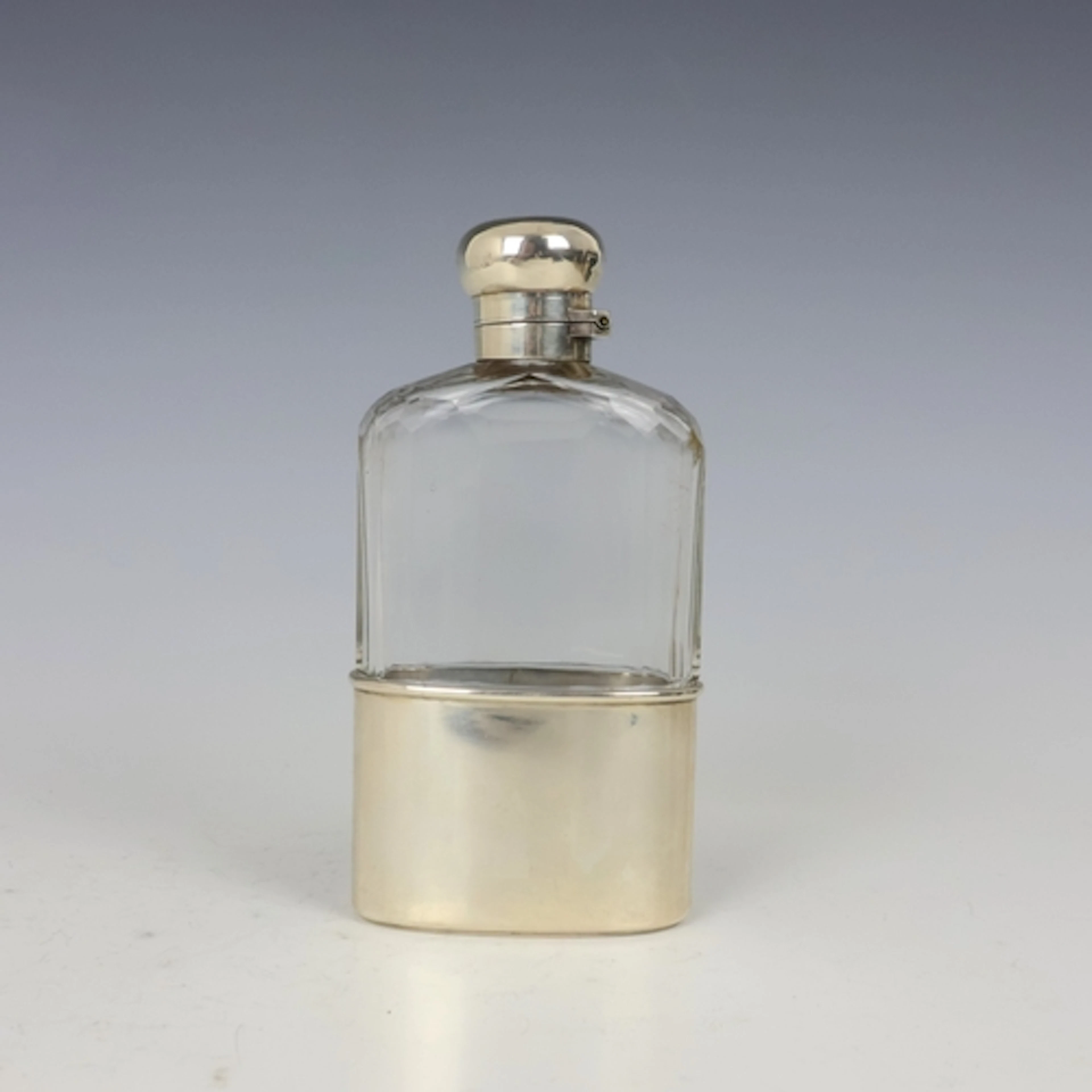 A Victorian silver mounted glass hipflask, London 1897, the ...
