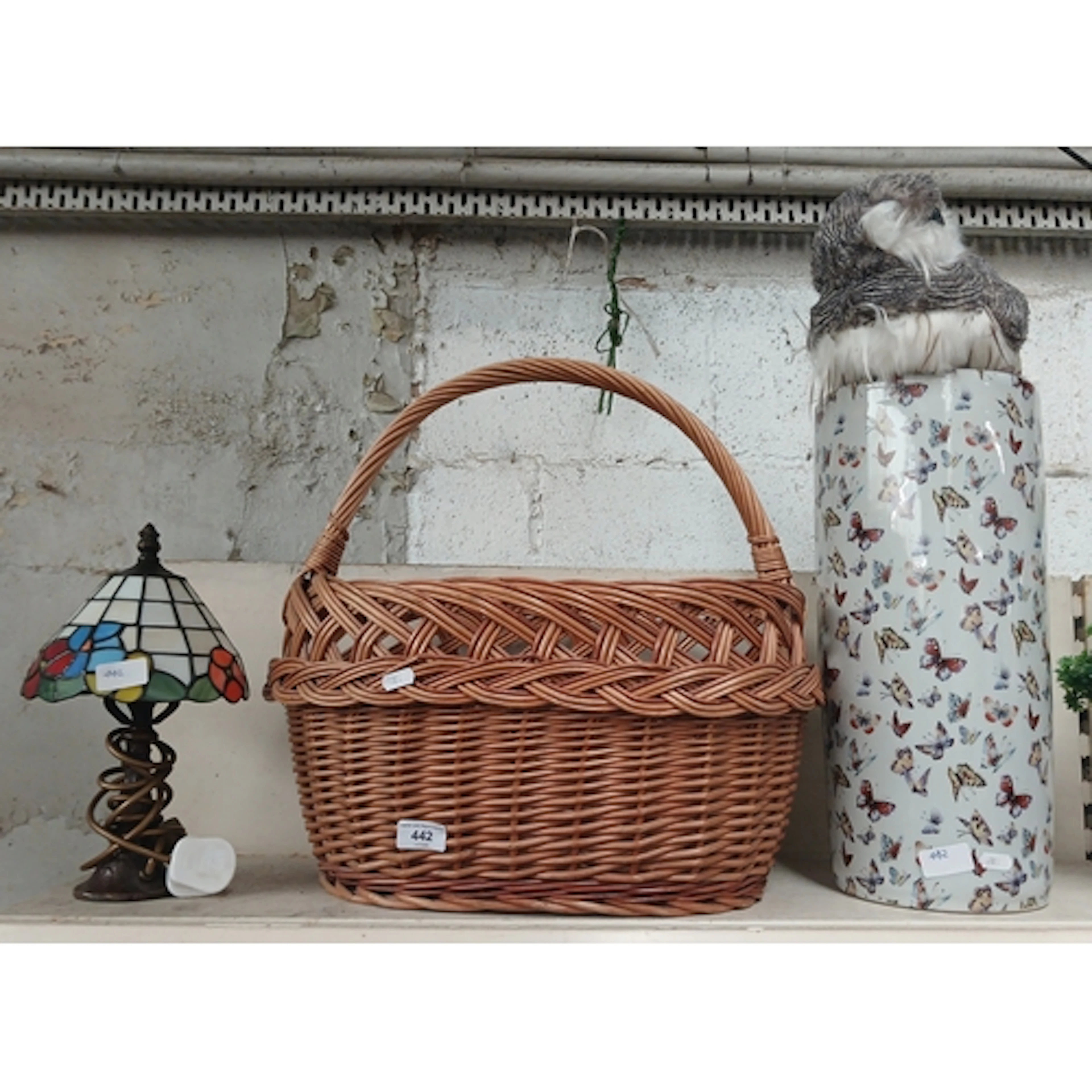 A large wicker shopping basket, stick stand with butterfly d...