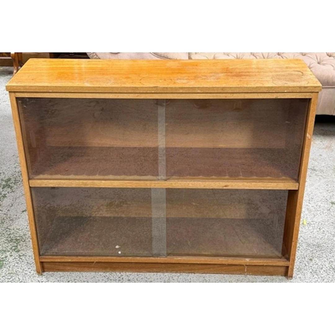 A glazed mid-century two shelf bookcase. Height 76cm 28x96cm...