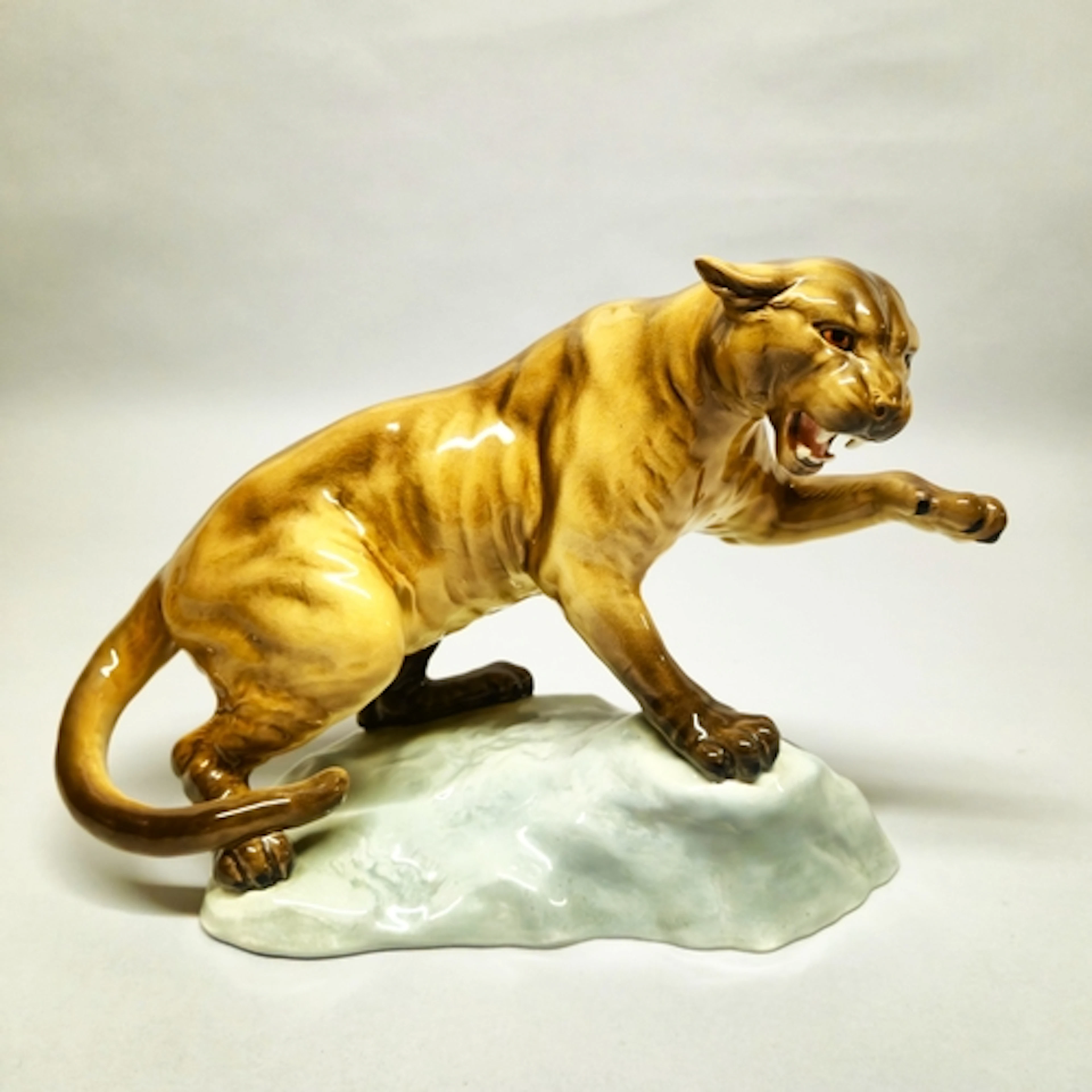 Beswick figure of a puma, glazed in brown with left paw rais...